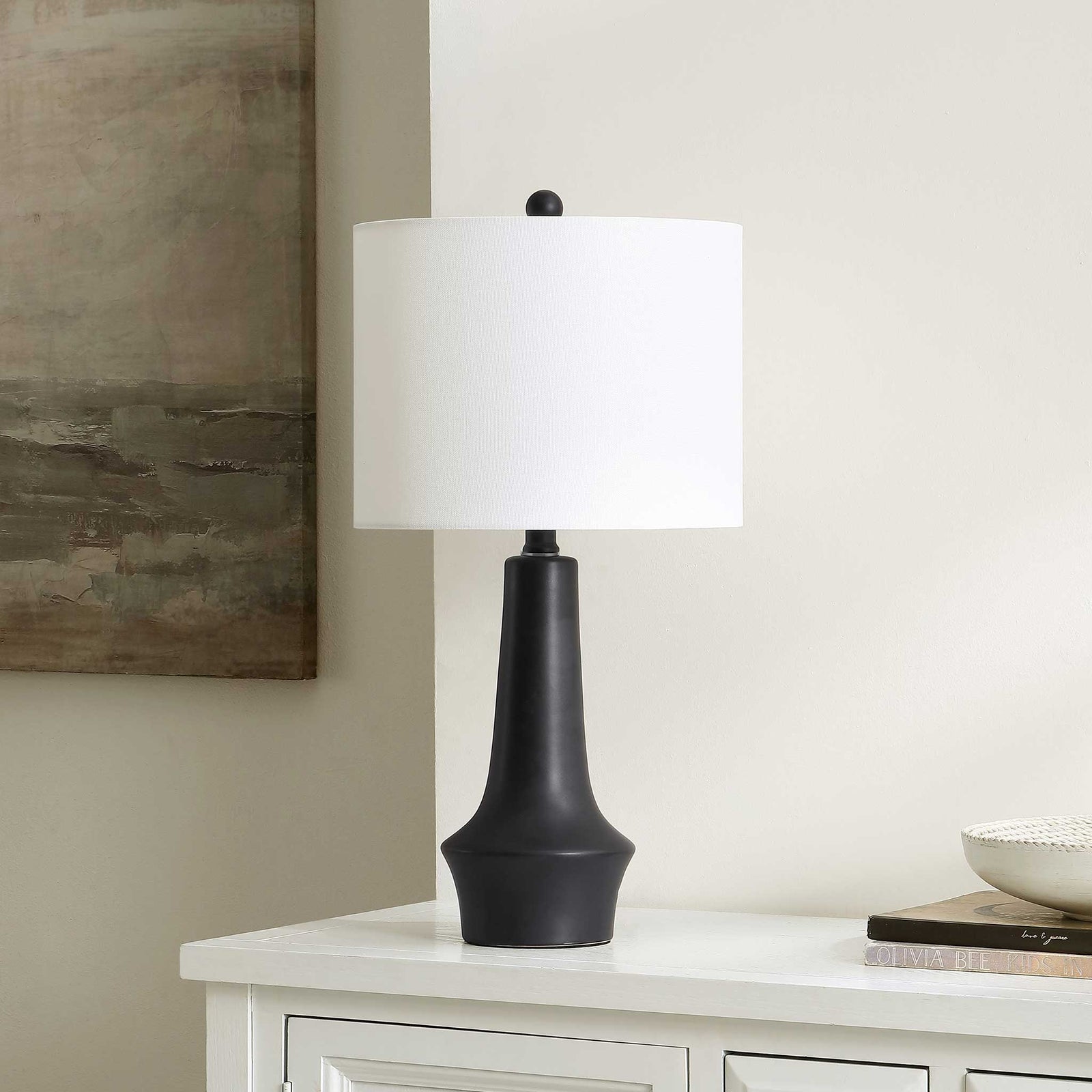 Modern black ceramic table lamp brings refined contrast with its white fabric shade. || TBL4514A || front_angle_room