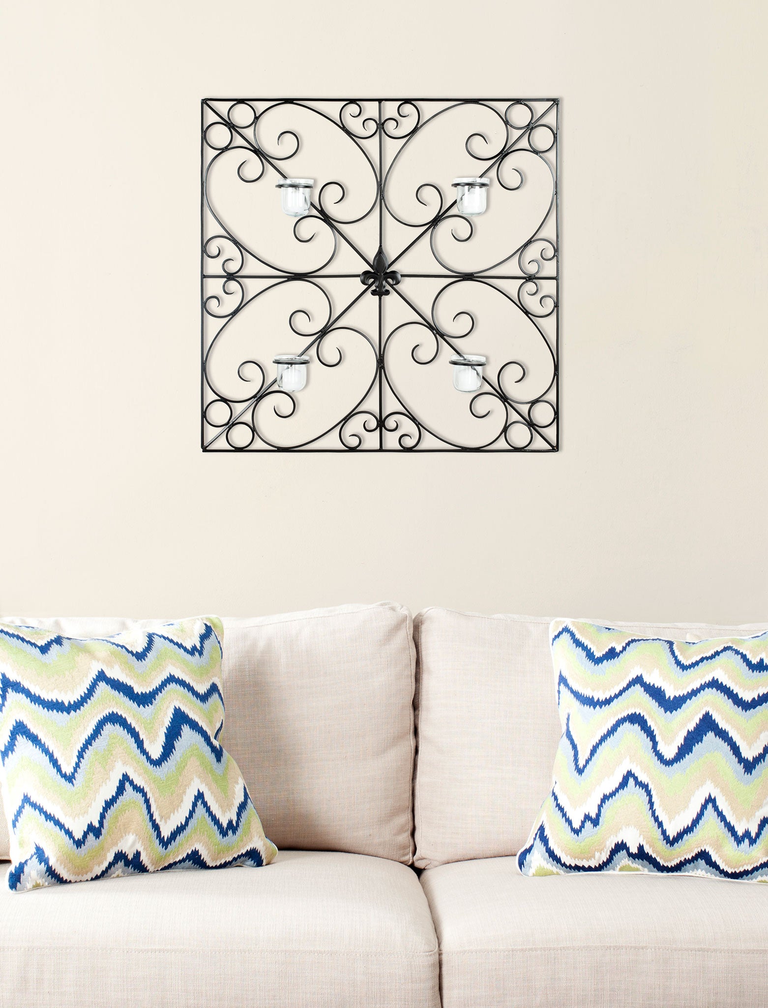Black iron scrollwork surrounds four glass votives in a symmetrical square wall accent. || WDC1005A || front_room