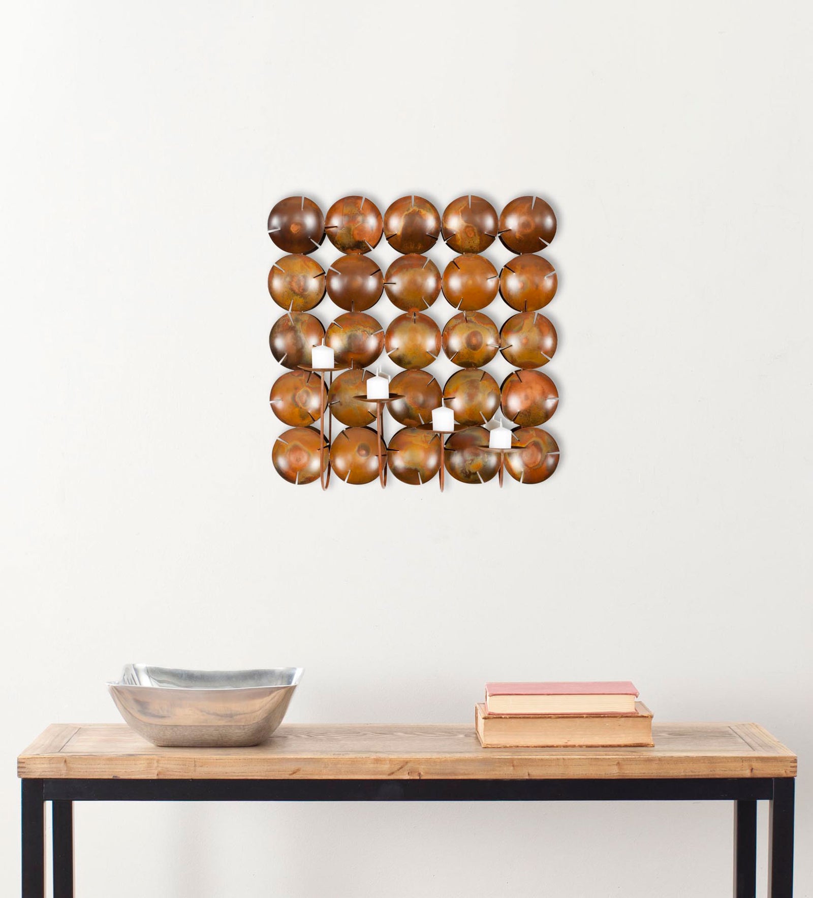 A square array of copper-toned discs and four candleholders warms the wall above a console. || WDC1020A || front_room