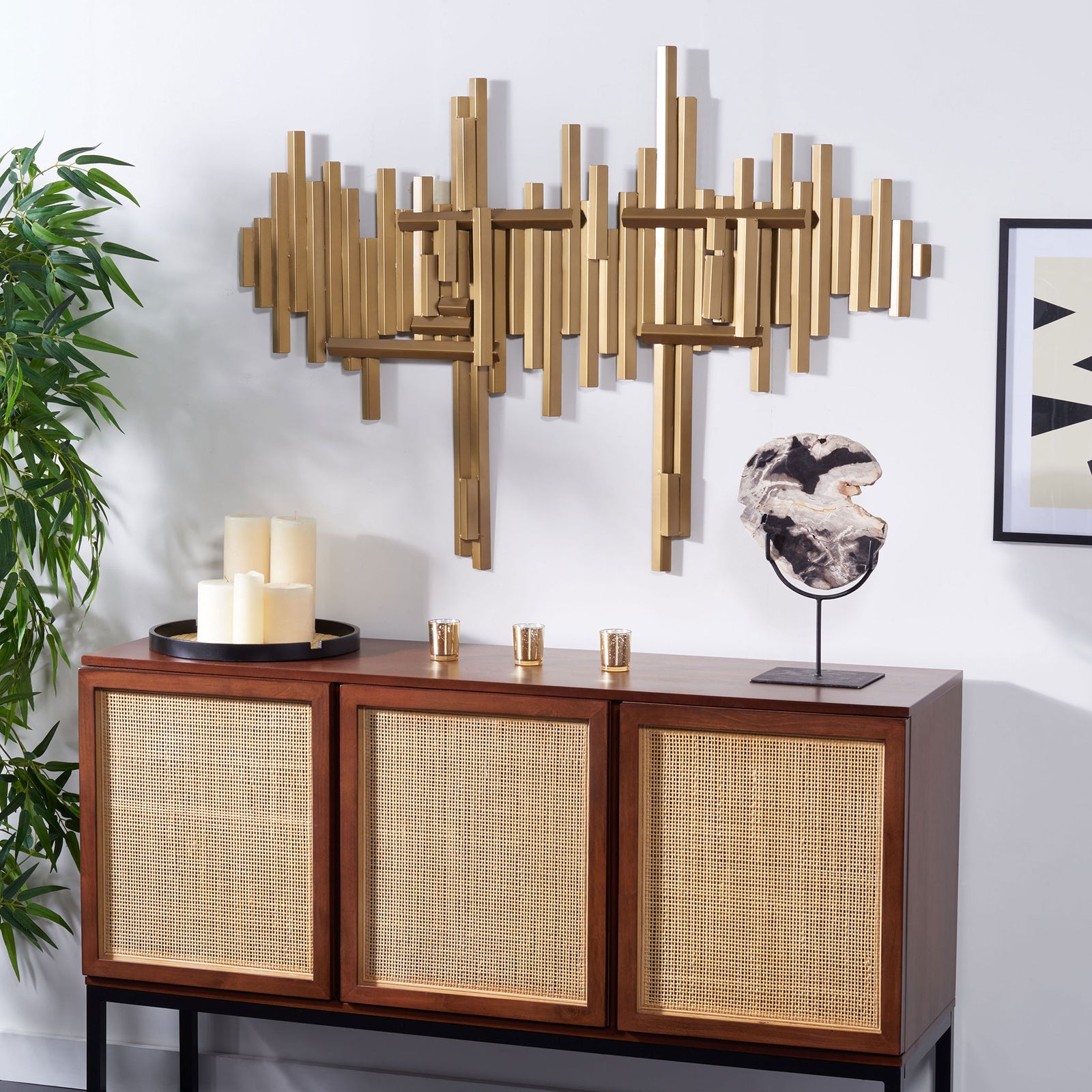 Antique brass wall sculpture adds layered metallic texture and architectural flair above a credenza || WDC1028A || front_room