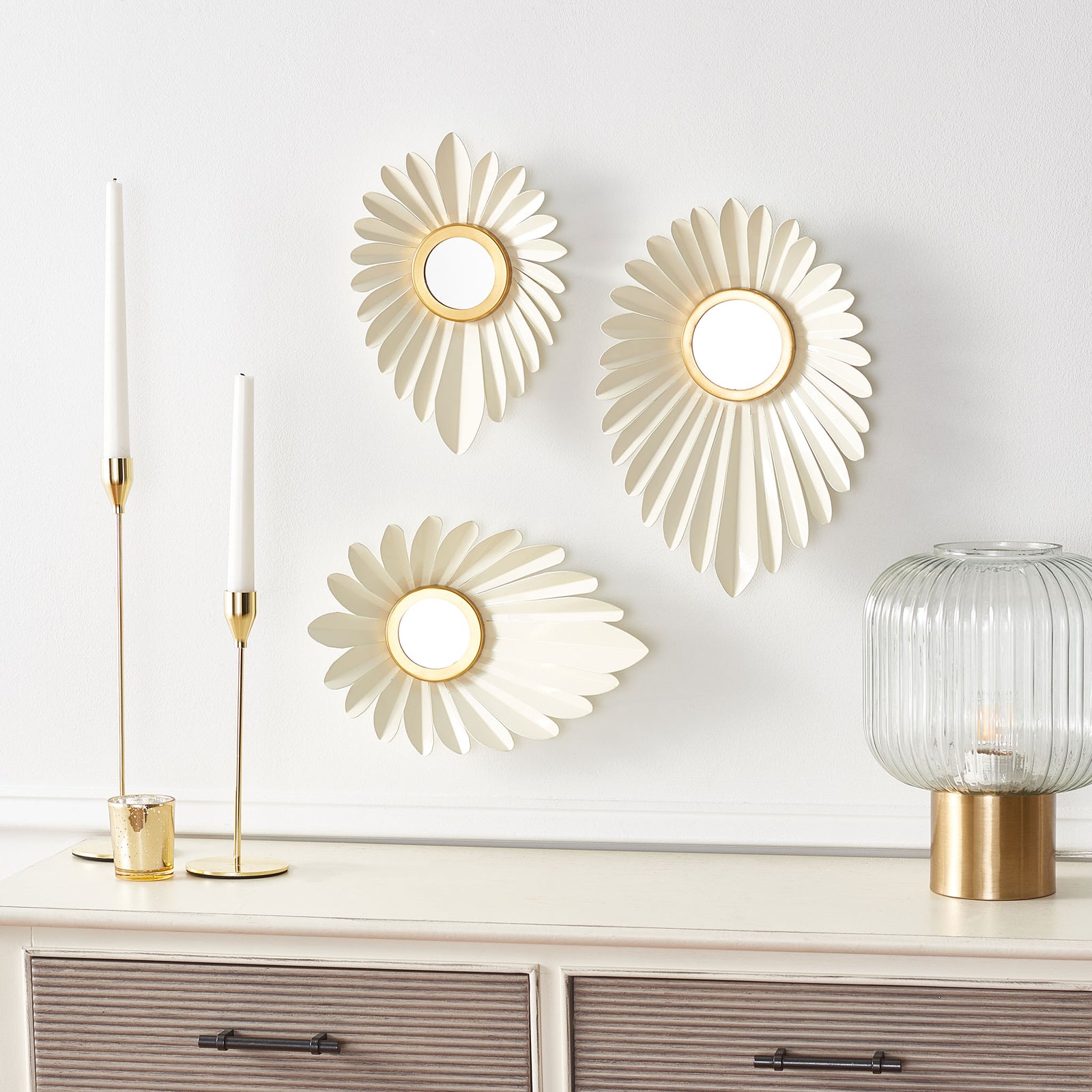 Three ivory petal wall mirrors with gold centers add sculptural charm above a console || WDC3000A || front_room
