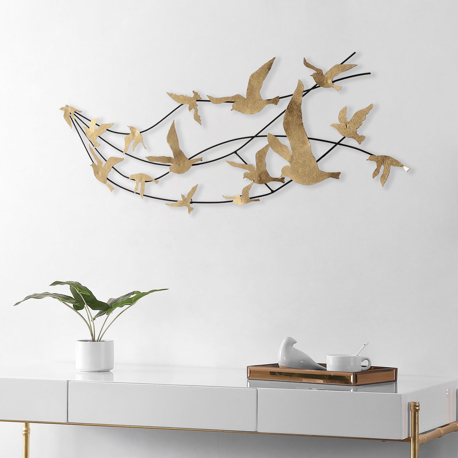 Gilded birds sweep above a console, adding airy movement and warmth to the room. || WDC5004A || front_room