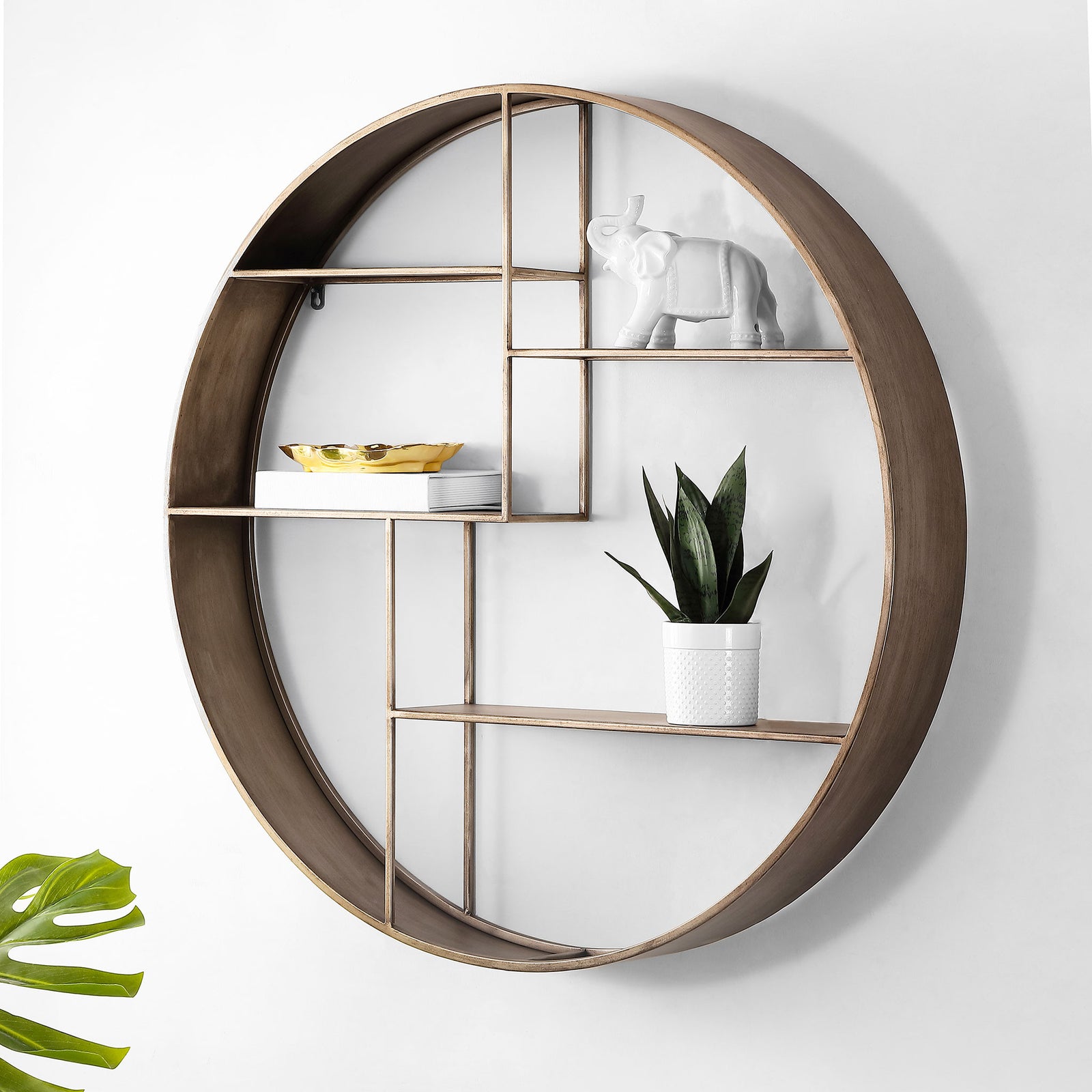 A circular brown metal wall shelf displays a potted plant and decorative accents on staggered shelves. || WDC5010A || front_angle_room