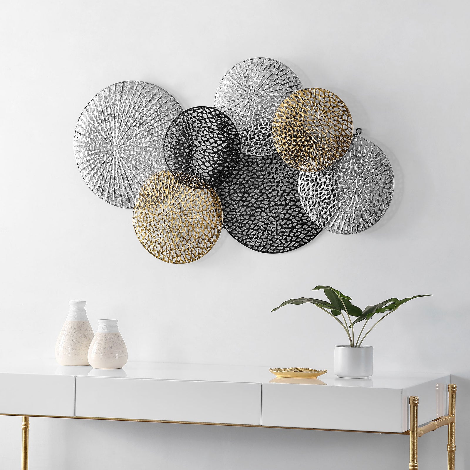 Airy metallic disks add depth and visual interest above a modern console. || WDC5019A || front_room