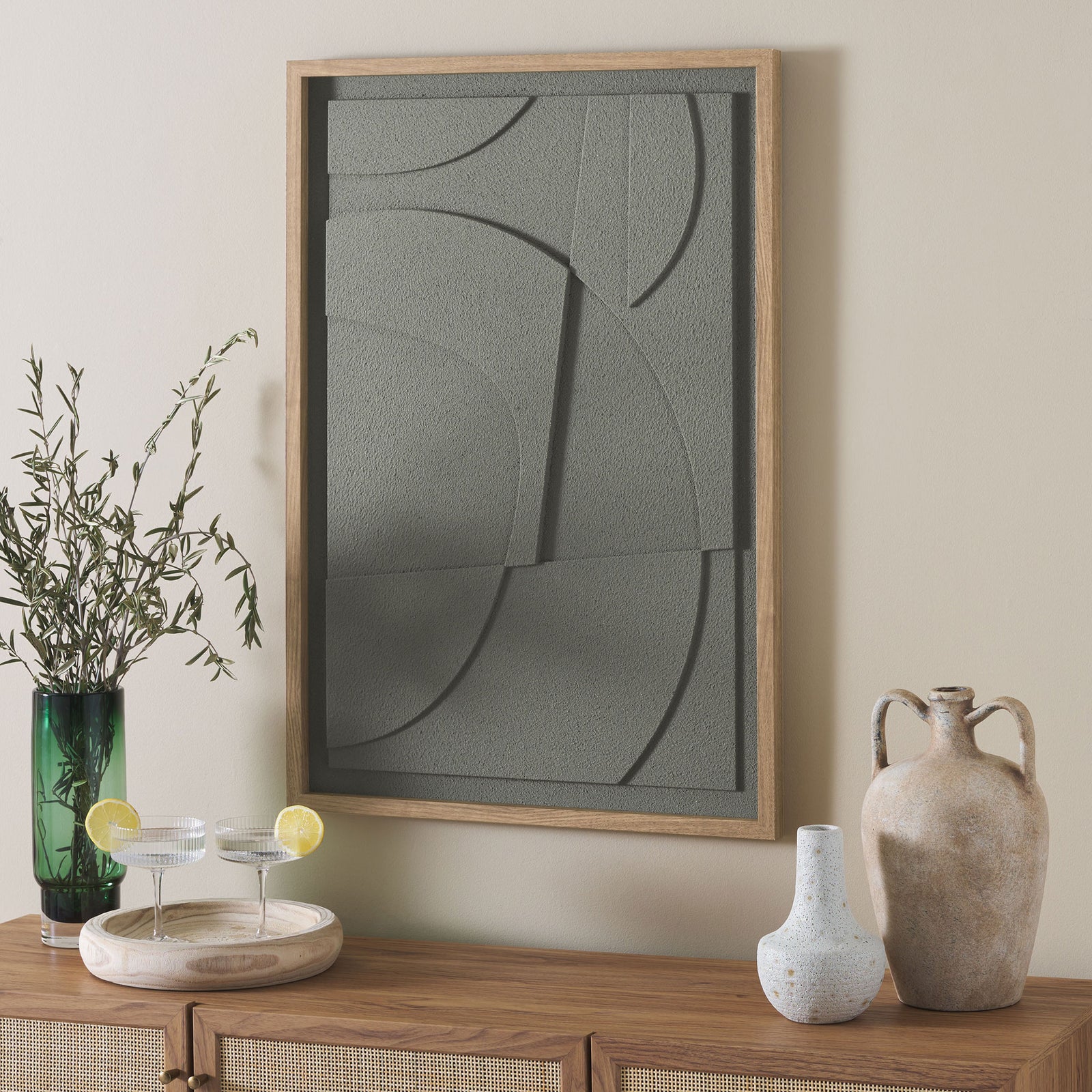 Green dimensional wall art adds curved shapes and quiet texture above a wood console || WLA3024A || front_room