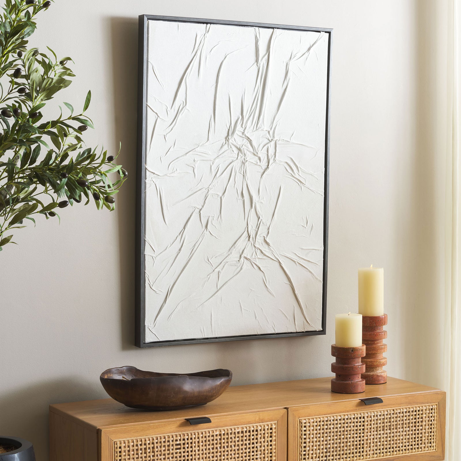 Organic white relief art with a slim dark border adds quiet texture to a neutral room || WLA3026A || front_angle_room