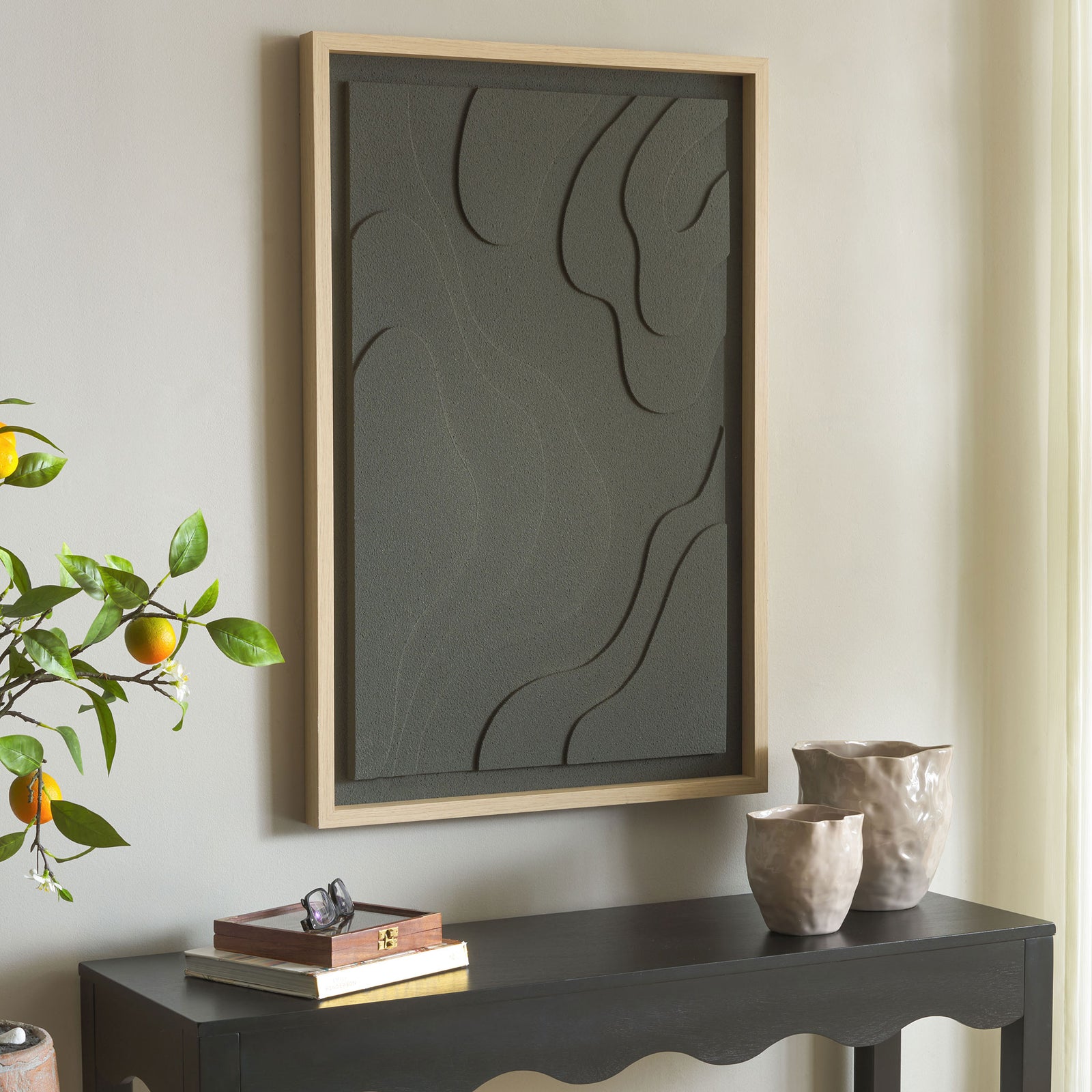 Charcoal abstract art adds subtle texture and sweeping organic lines above a dark console. || WLA3031A || front_angle_room