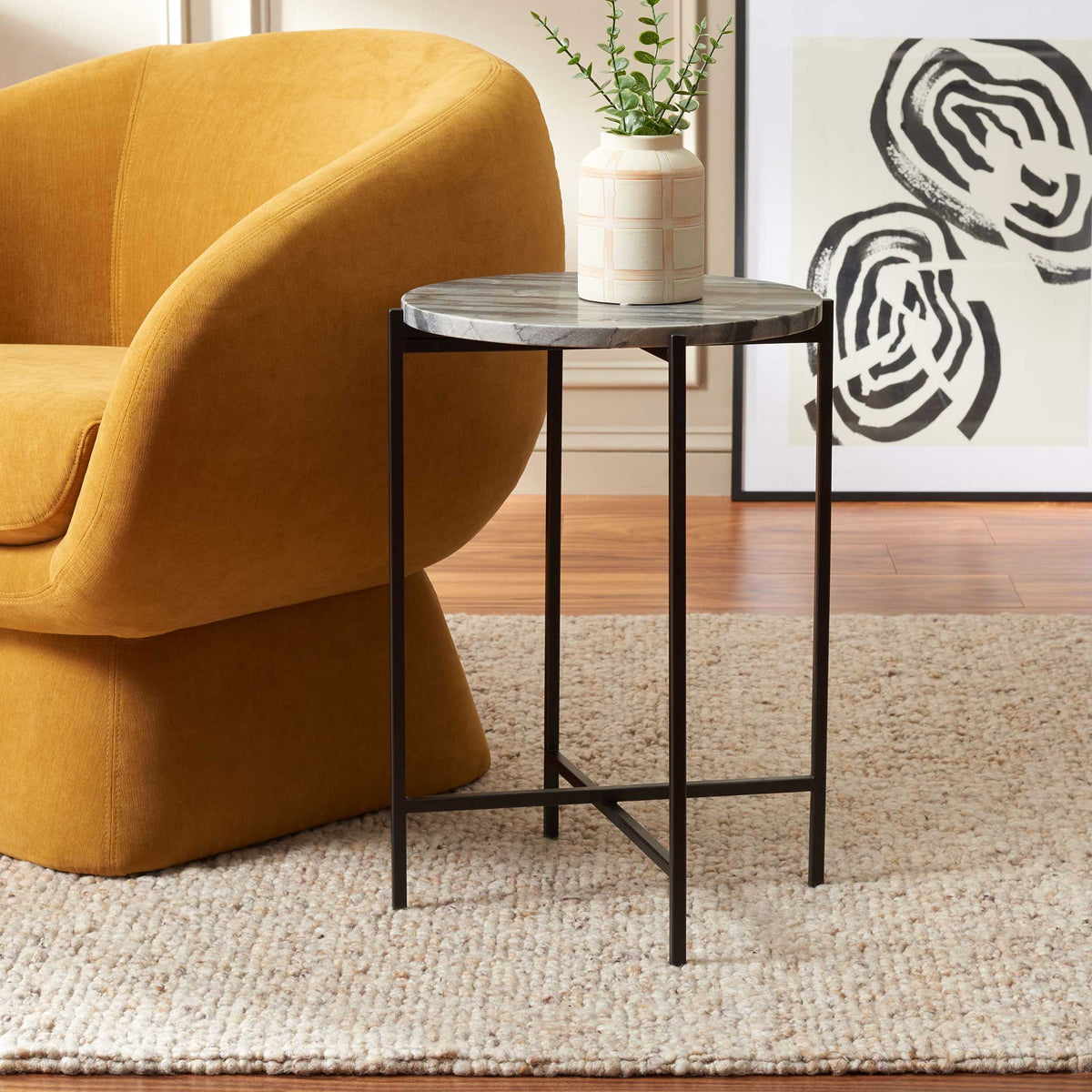 Marble-topped accent table adds modern contrast beside a cozy lounge chair || ACC4604A || front_angle_room