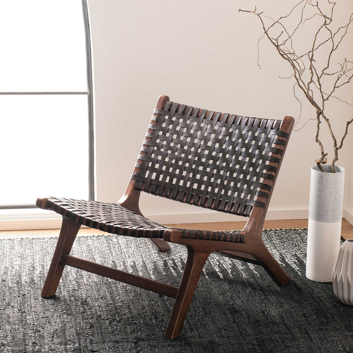 A dark leather lattice and warm wood frame complement a softly sunlit living space.