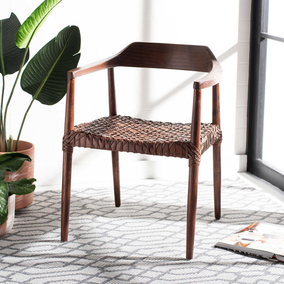 Deep walnut wood and cognac leather weaving create a warm, inviting accent chair