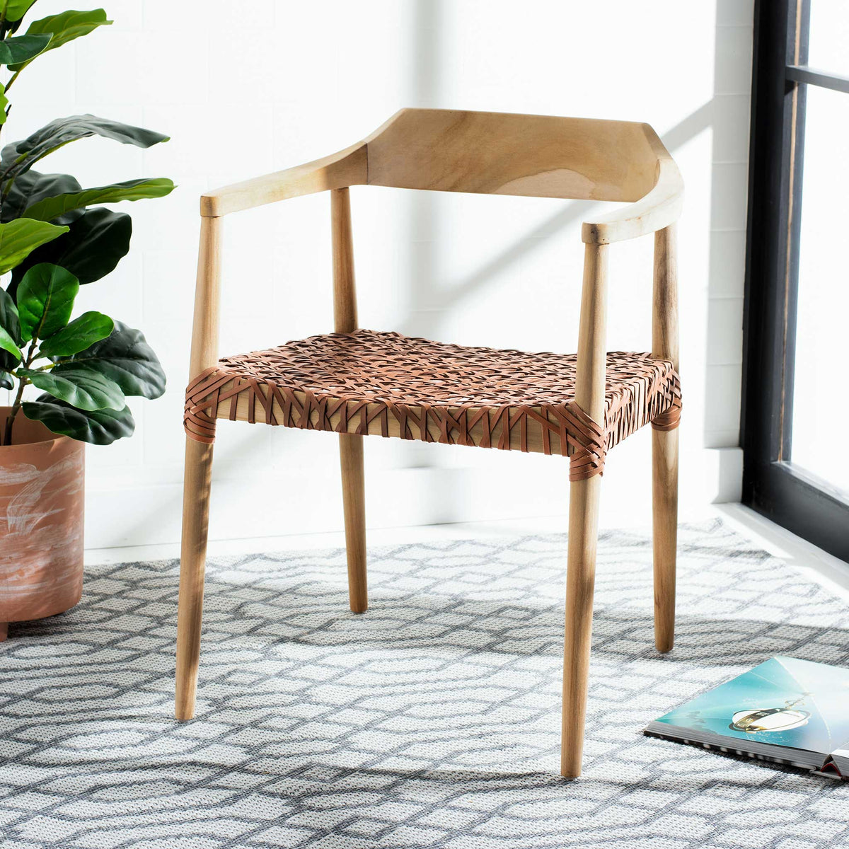 Warm teak and brown woven leather bring inviting texture to a light-filled corner