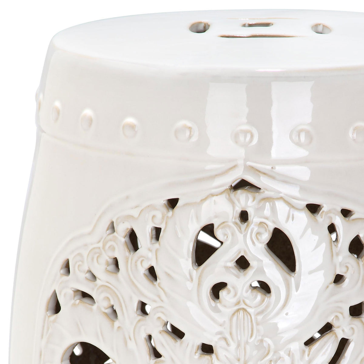 Lustrous cream glaze highlights raised beading and curling floral scrollwork.