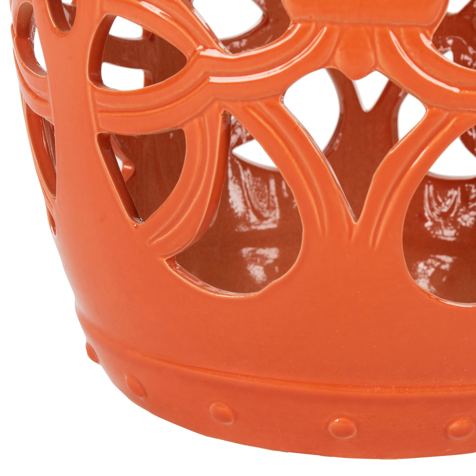 Curving vine cutouts meet a rounded base with raised dots in glossy orange ceramic || ACS4539D || leg_studio