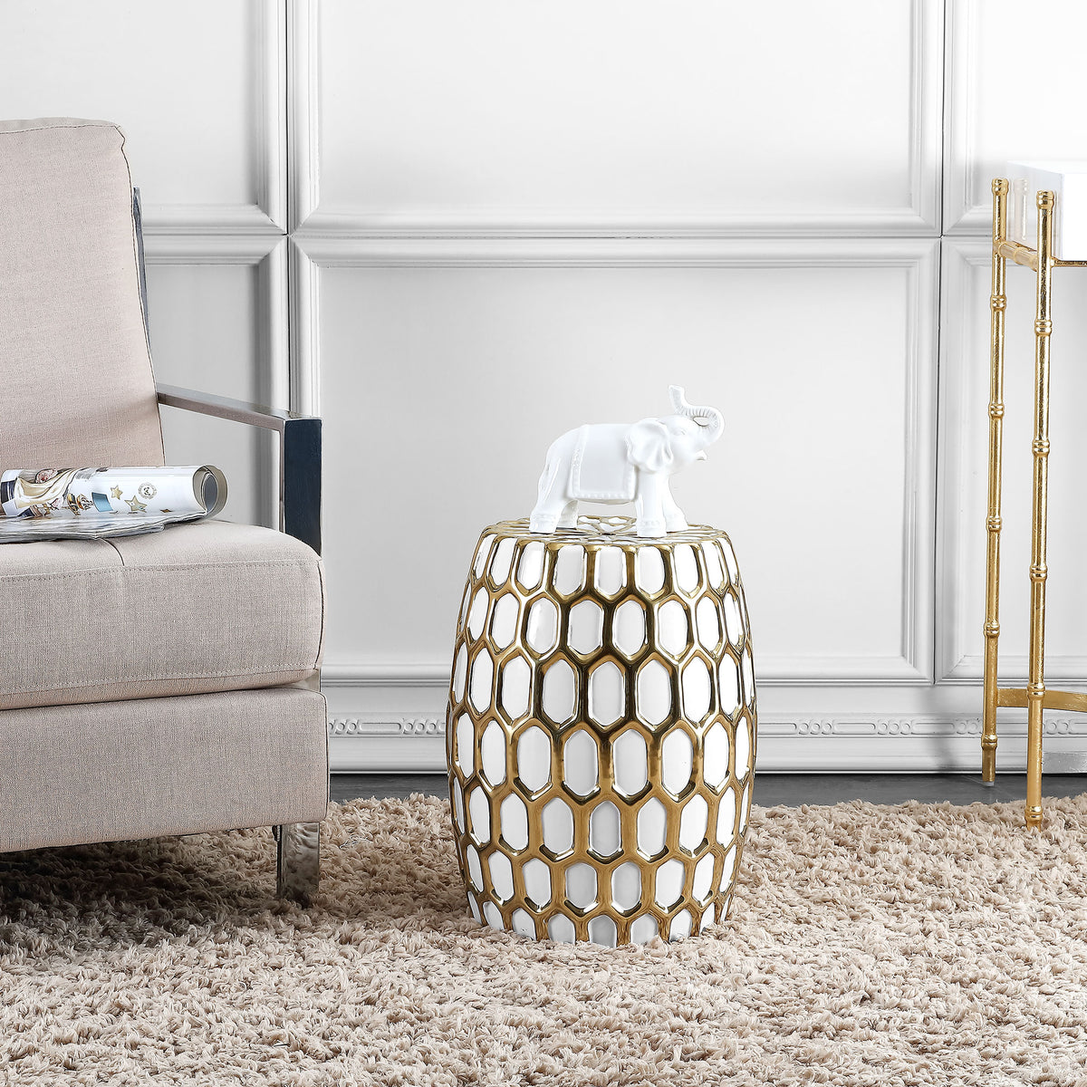 Gold lattice over white ceramic adds a sculptural accent beside a softly upholstered chair || ACS4587A || front_angle_room