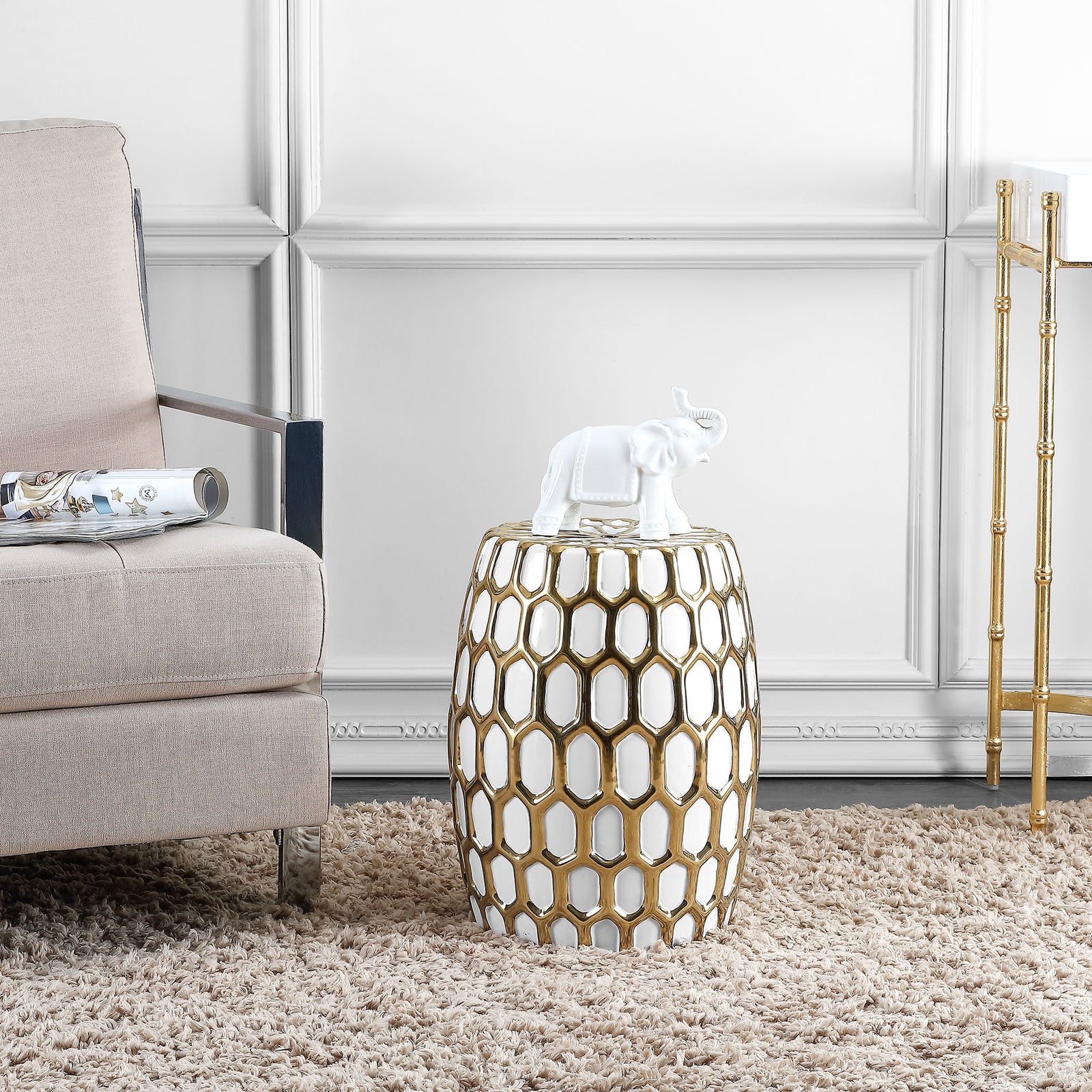 Gold lattice over white ceramic adds a sculptural accent beside a softly upholstered chair || ACS4587A || front_angle_room