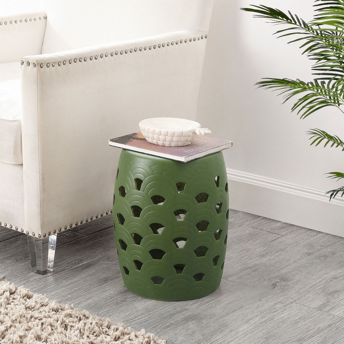 Moss green openwork stool adds color beside an upholstered chair while serving as a side table. || ACS4597B || front_room