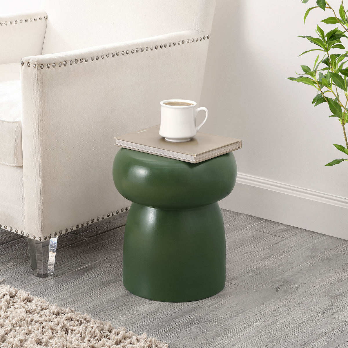 A moss green ceramic stool brings a sculptural side-table accent to a cozy seating area. || ACS4598C || front_room