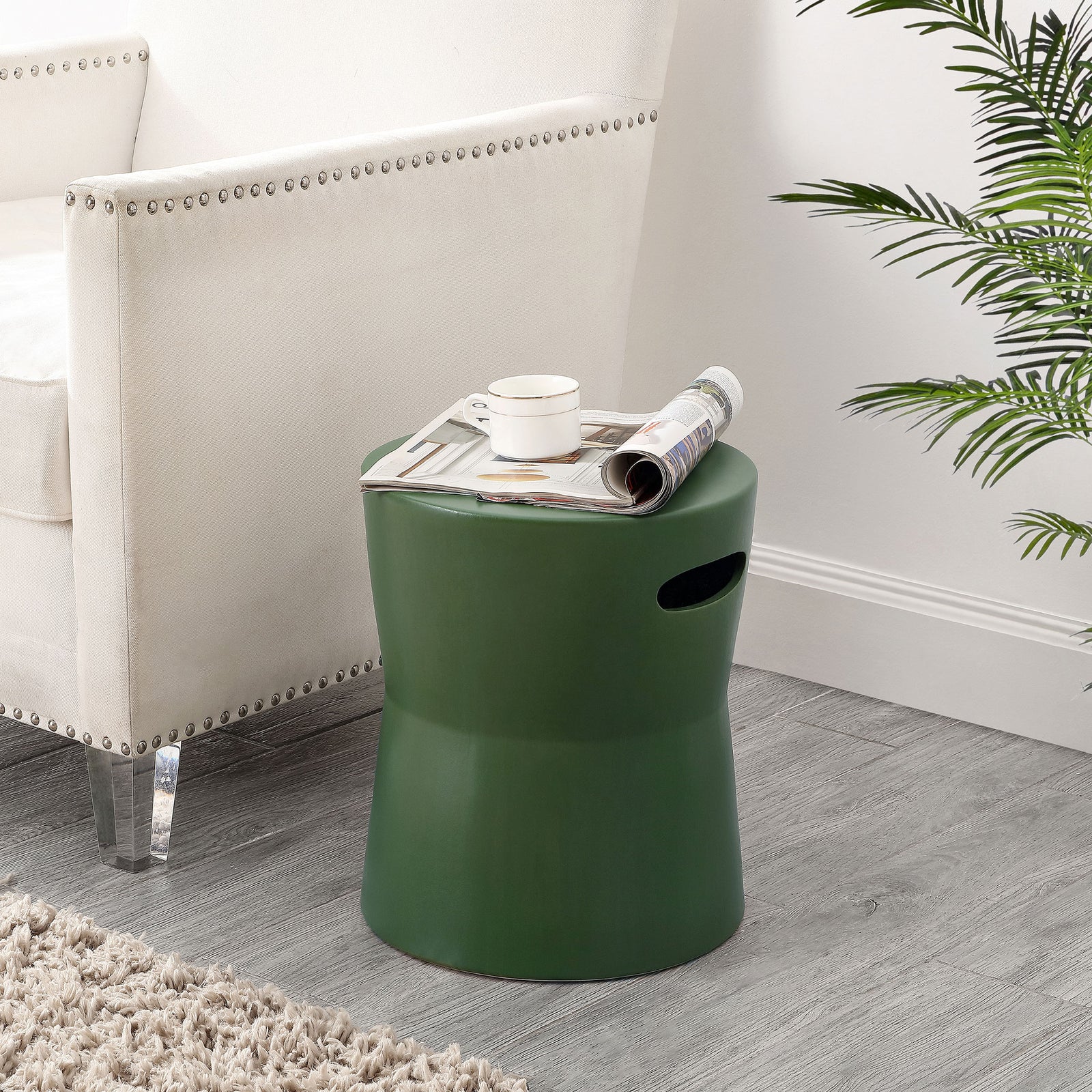 Moss-green ceramic stool doubles as a side table beside an upholstered chair || ACS4599D || front_angle_room