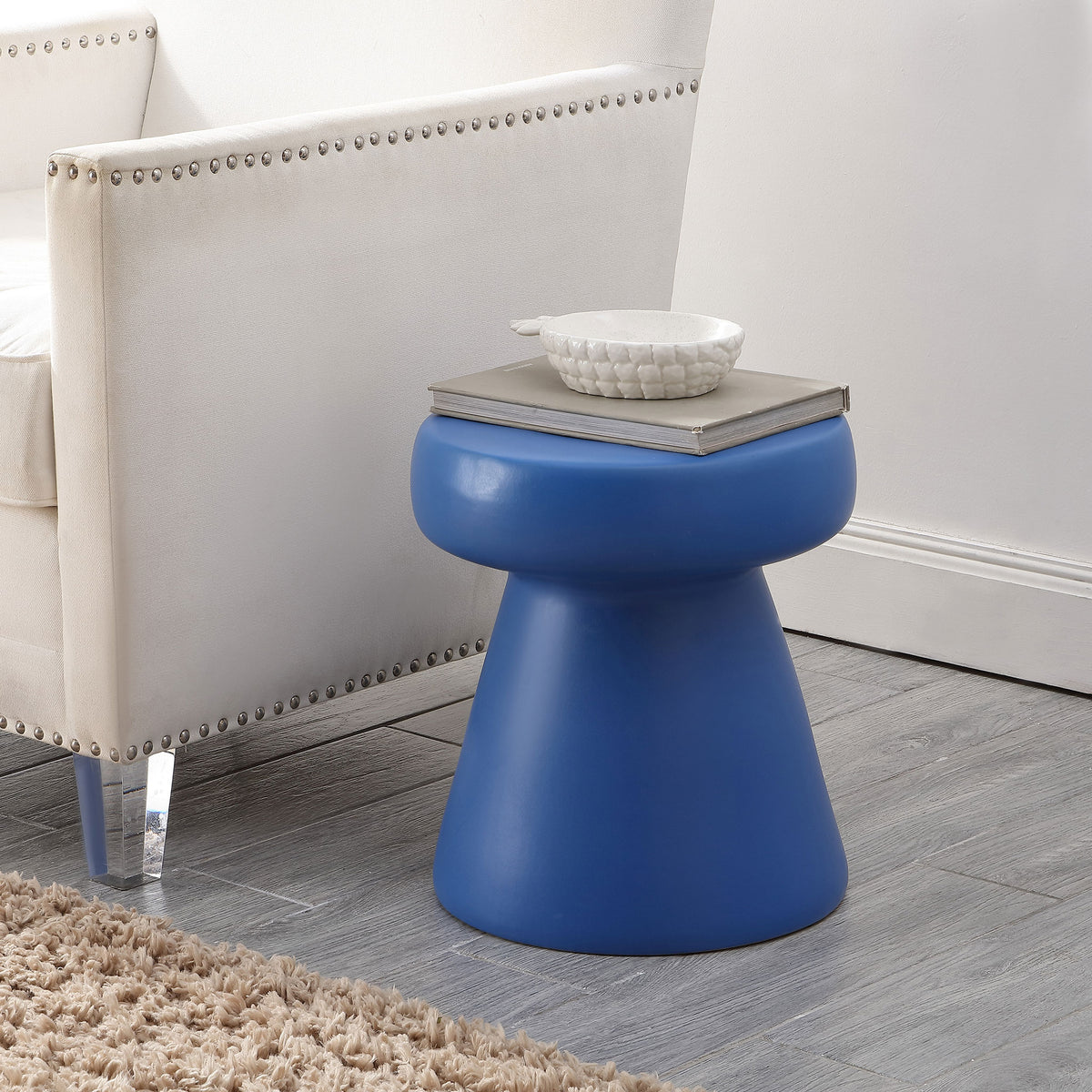 Cobalt blue ceramic stool adds a bright side-table accent beside a neutral upholstered chair || ACS4603D || front_angle_room