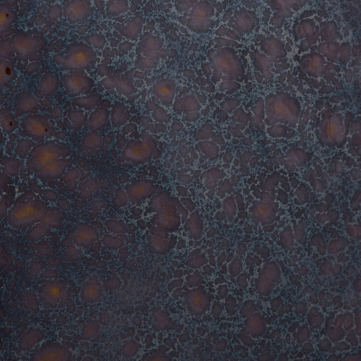 Mottled dark blue glaze reveals warm amber spots and a fine web of pale lines. || ACS4609B || swatch_studio
