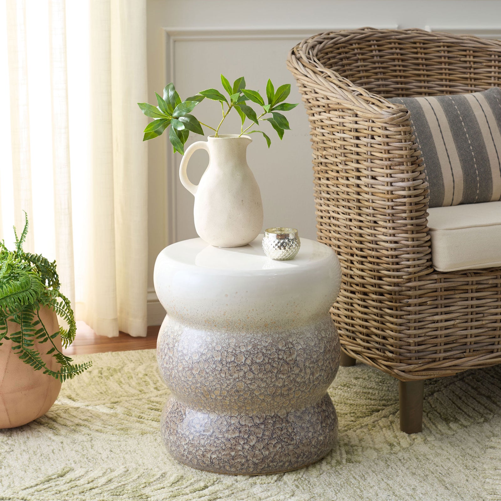 Glossy white and gray ceramic stool serves as a charming side table for greenery and decor. || ACS4612A || front_angle_room