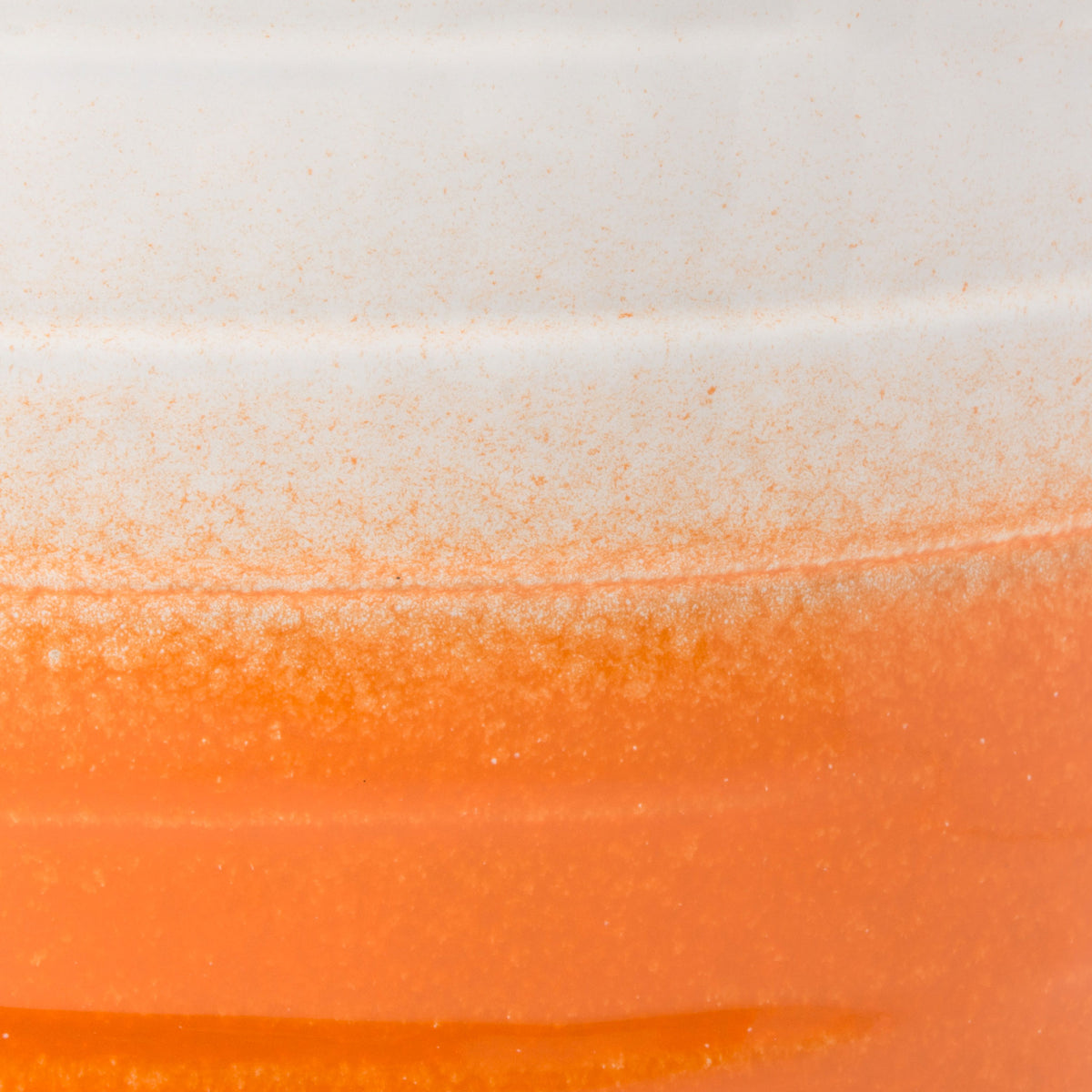 A speckled transition blends glossy white into warm orange over sculpted ceramic bands. || ACS5201C || swatch_studio