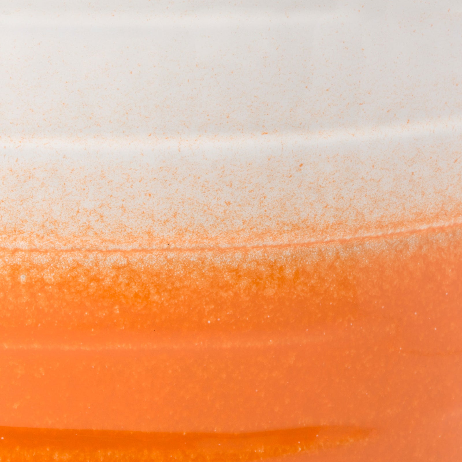 A speckled transition blends glossy white into warm orange over sculpted ceramic bands. || ACS5201C || swatch_studio