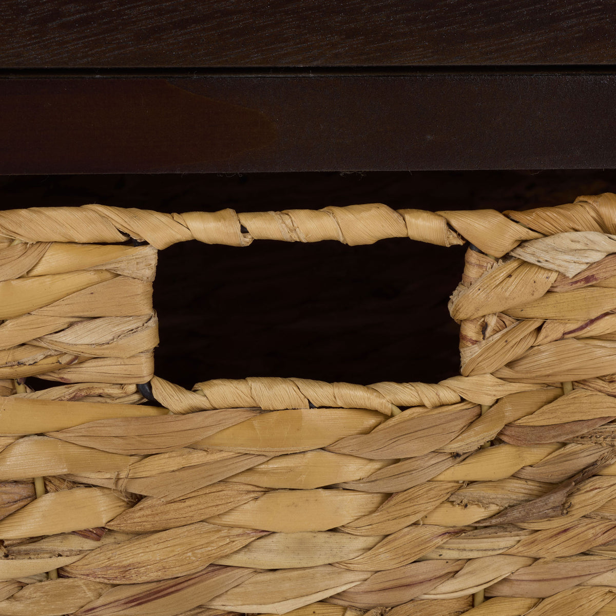 A woven basket adds natural texture and an easy-grip cutout handle to the brown storage table. || AMH5700H || handle_studio