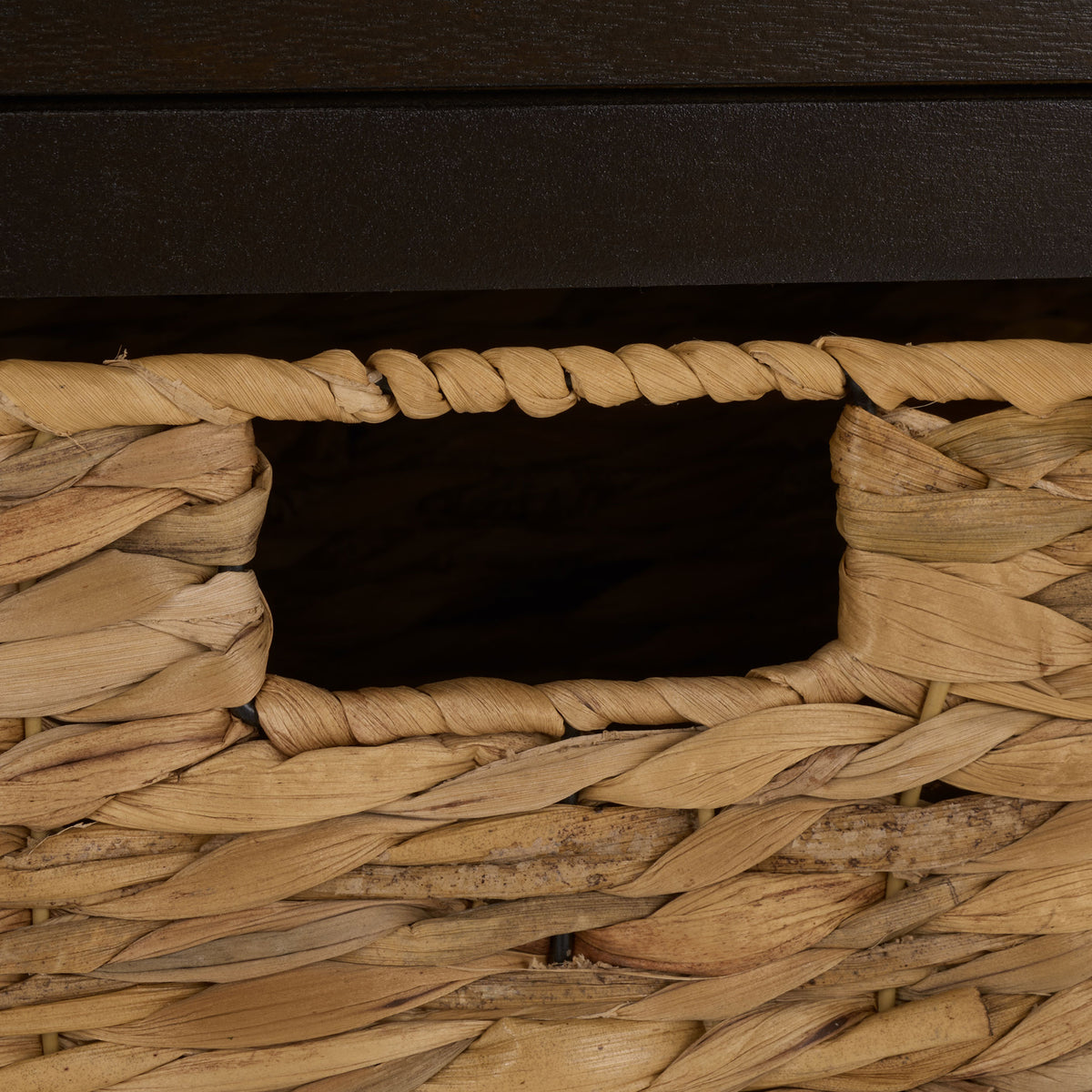 A rope-edged cutout handhold adds easy access to a natural woven basket. || AMH5702H || handle_studio