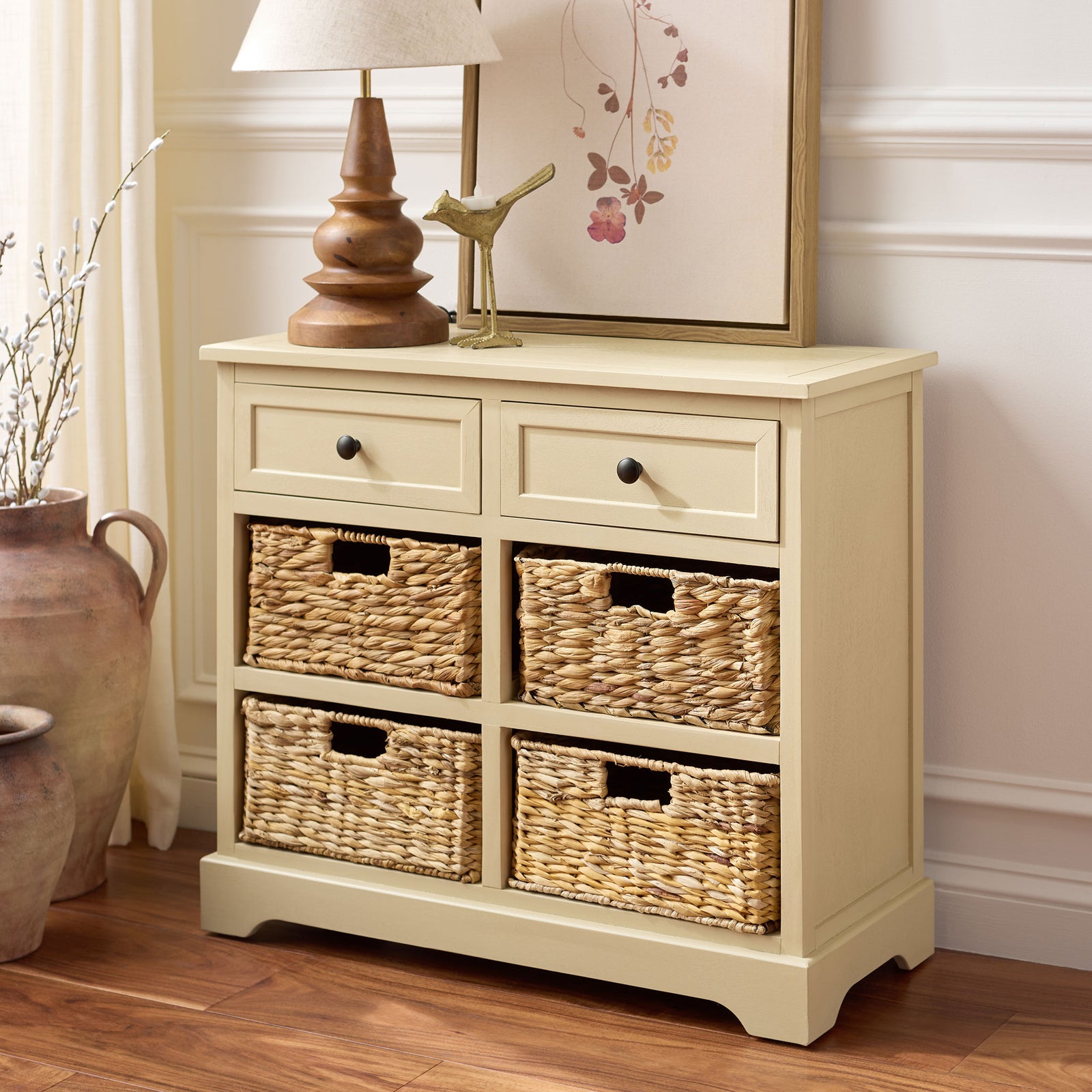 A sand-colored cabinet adds easy storage with four woven baskets and two drawers. || AMH5702J || front_angle_room
