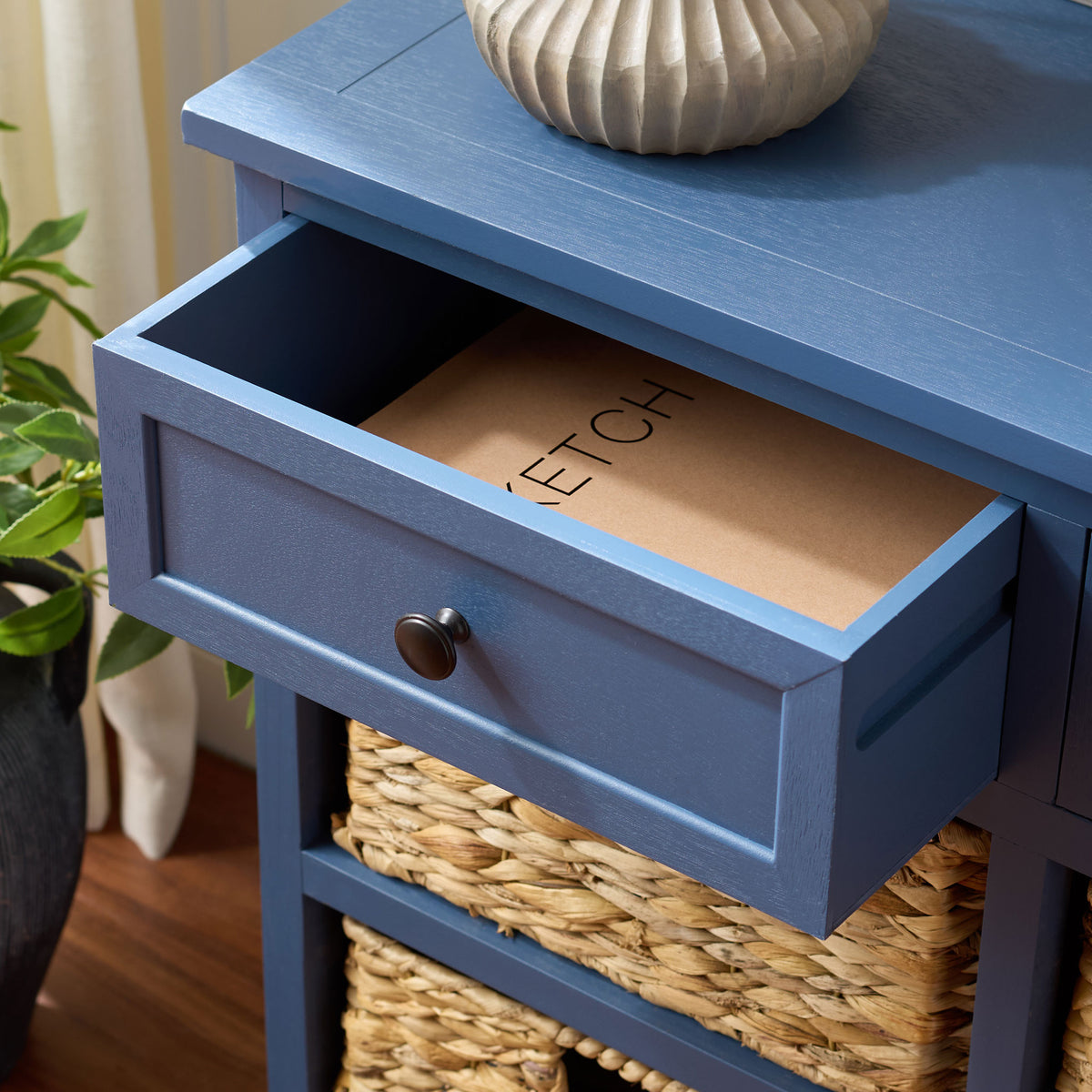 An open blue drawer offers handy storage above the cabinet's natural woven baskets. || AMH5702K || storage_open_room