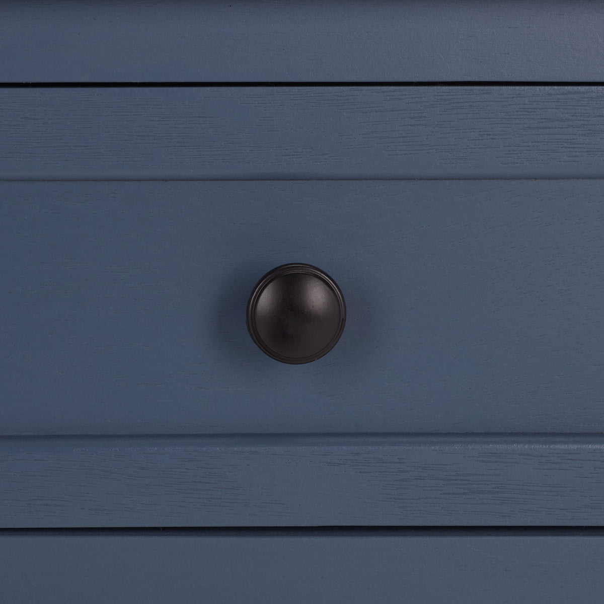 An antique black round knob contrasts with the blue drawer's textured finish. || AMH5702K || handle_studio