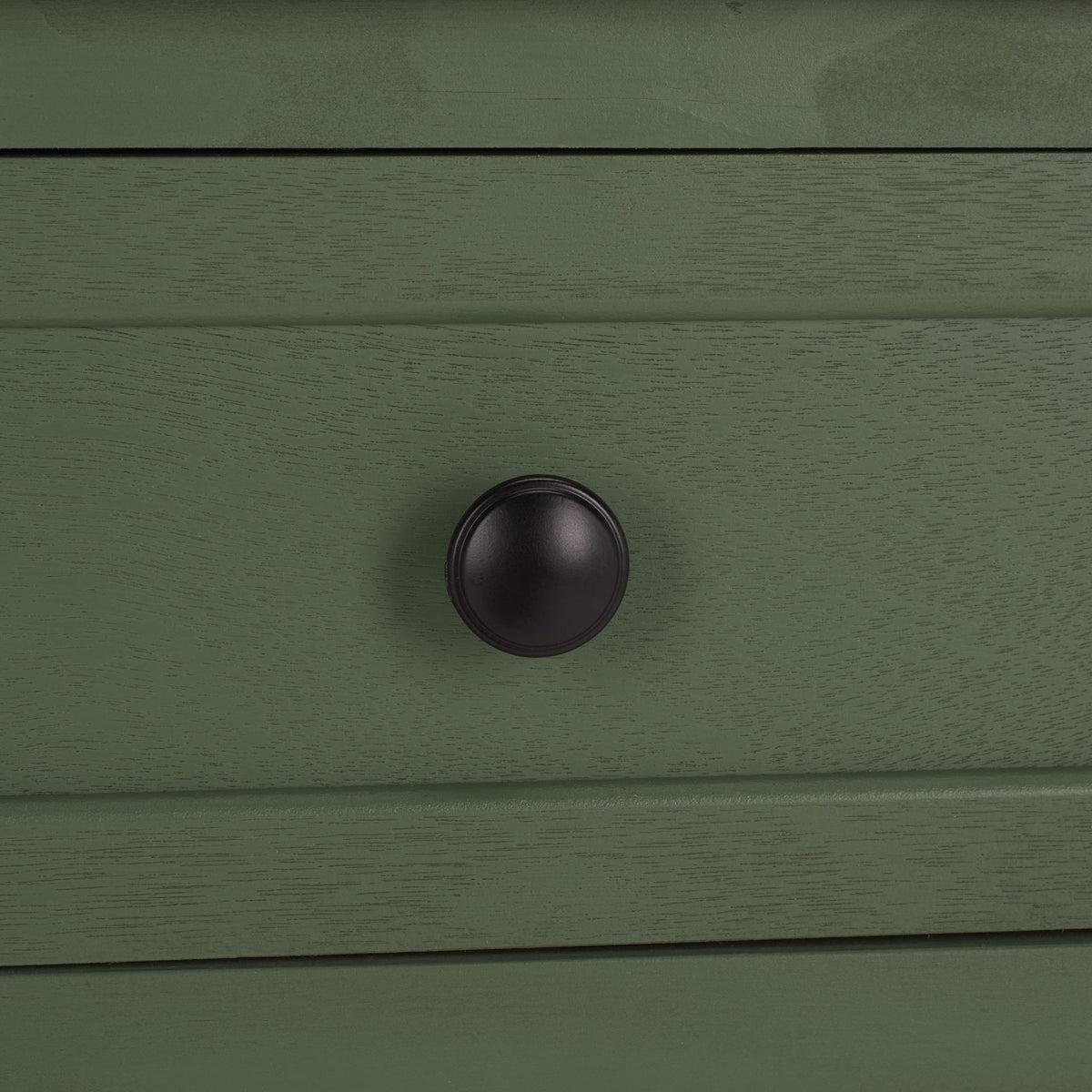 A dark round knob brings crisp contrast to the dusty green drawer. || AMH5702L || handle_studio