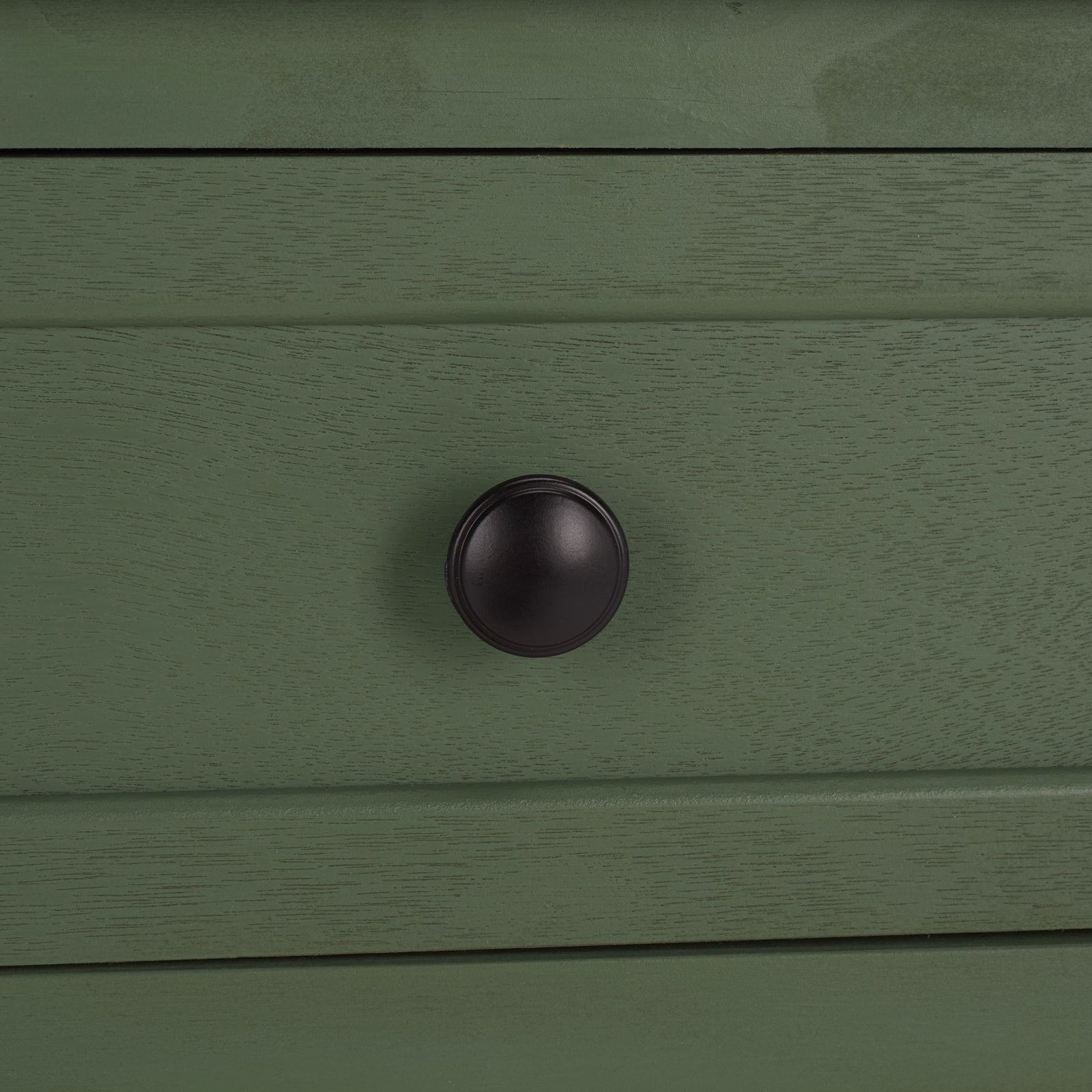 A dark round knob brings crisp contrast to the dusty green drawer. || AMH5702L || handle_studio