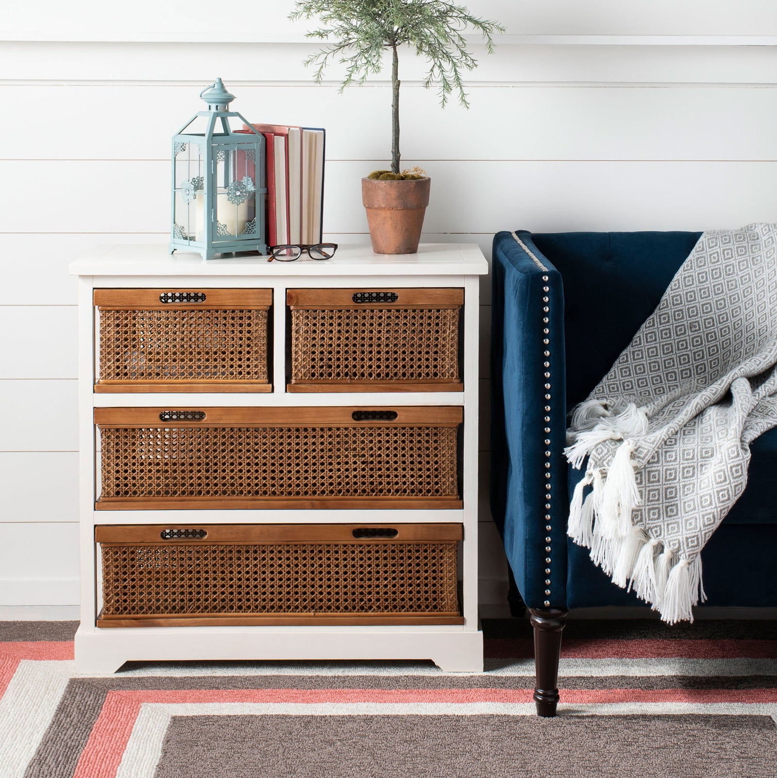 A cream storage cabinet pairs four warm cane baskets with a wide top for everyday display. || AMH6504A || front_room