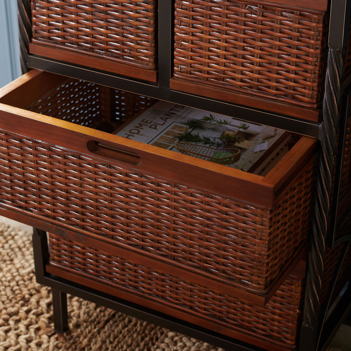 A pullout rattan basket keeps a favorite book tucked neatly within easy reach. || AMH6511A || storage_open_room
