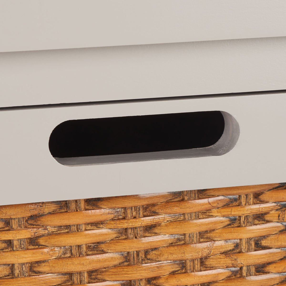 A recessed oval finger pull sits above the warm woven drawer inset || AMH6531C || handle_studio