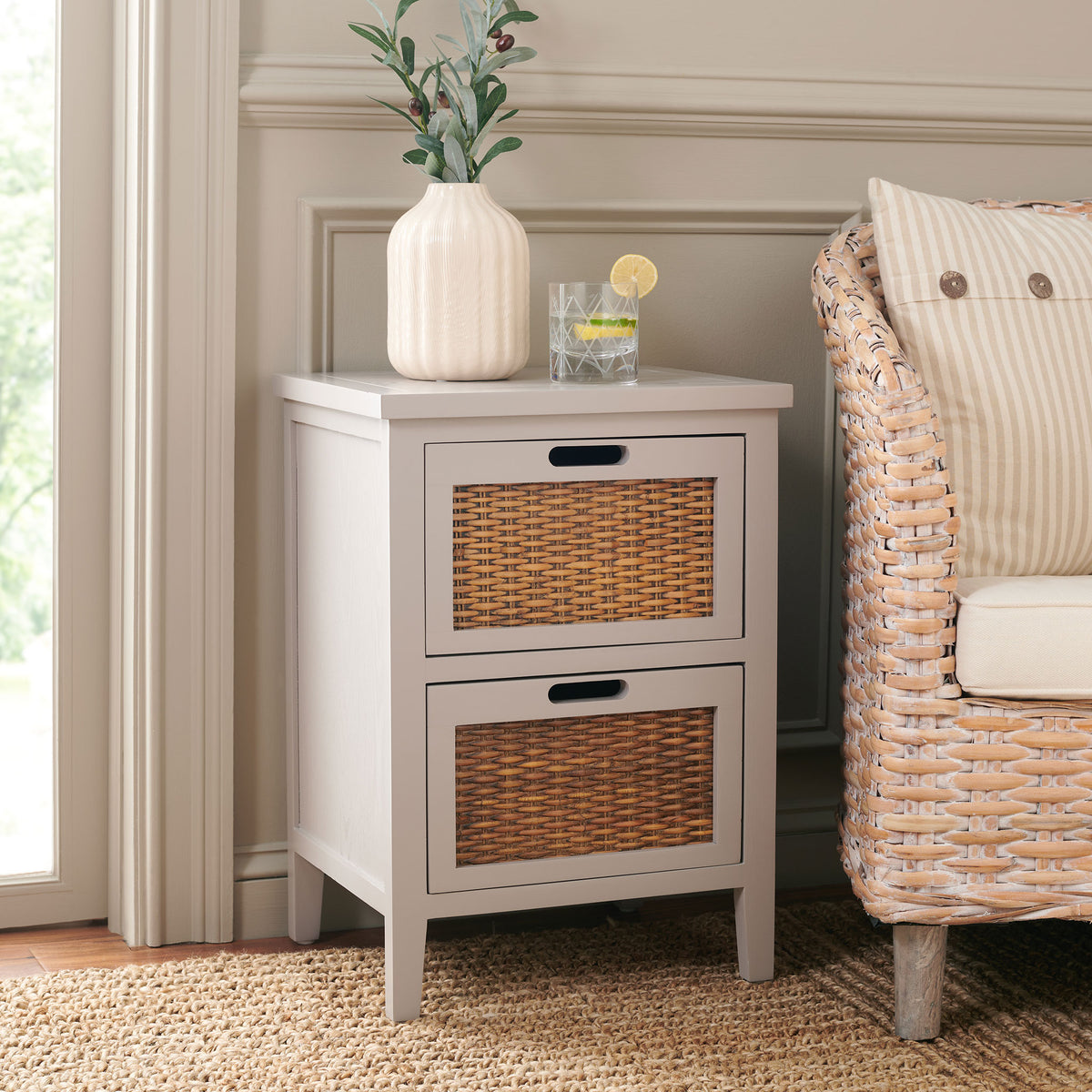 Soft gray table with two woven drawers adds compact storage beside a wicker chair || AMH6531C || front_angle_room