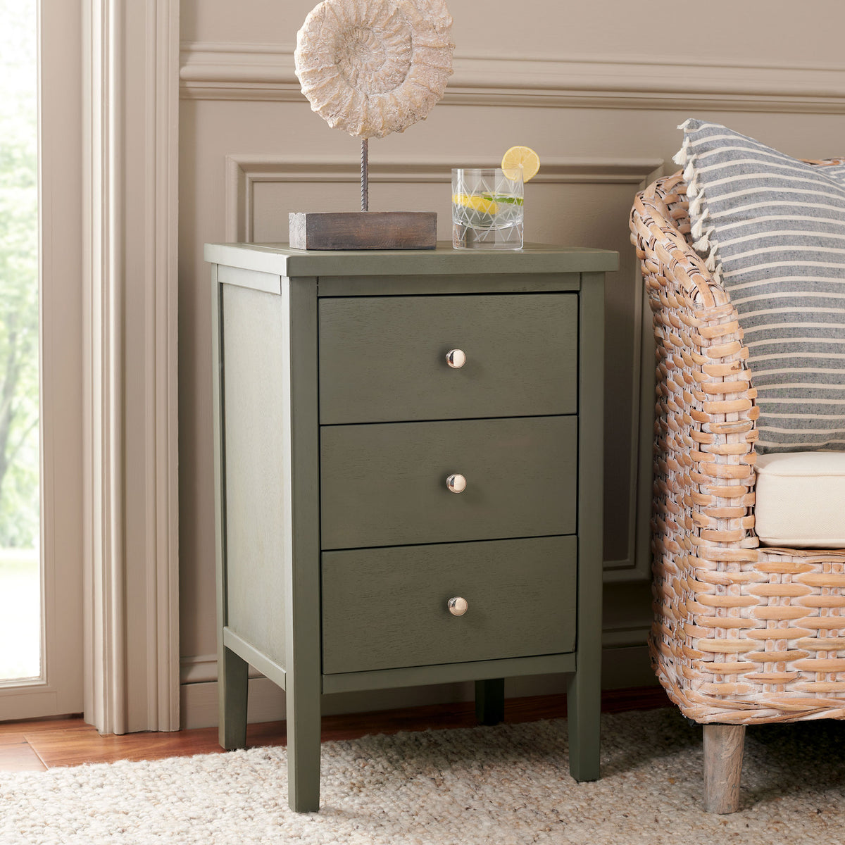 Three ash gray drawers and polished silver knobs offer stylish storage beside a lounge chair. || AMH6628A || front_angle_room