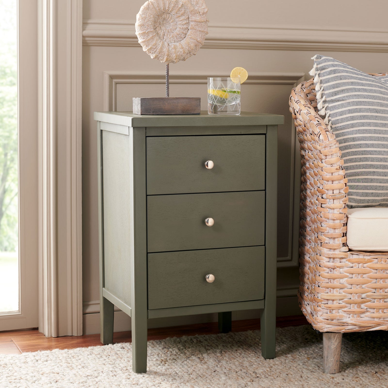 Three ash gray drawers and polished silver knobs offer stylish storage beside a lounge chair. || AMH6628A || front_angle_room