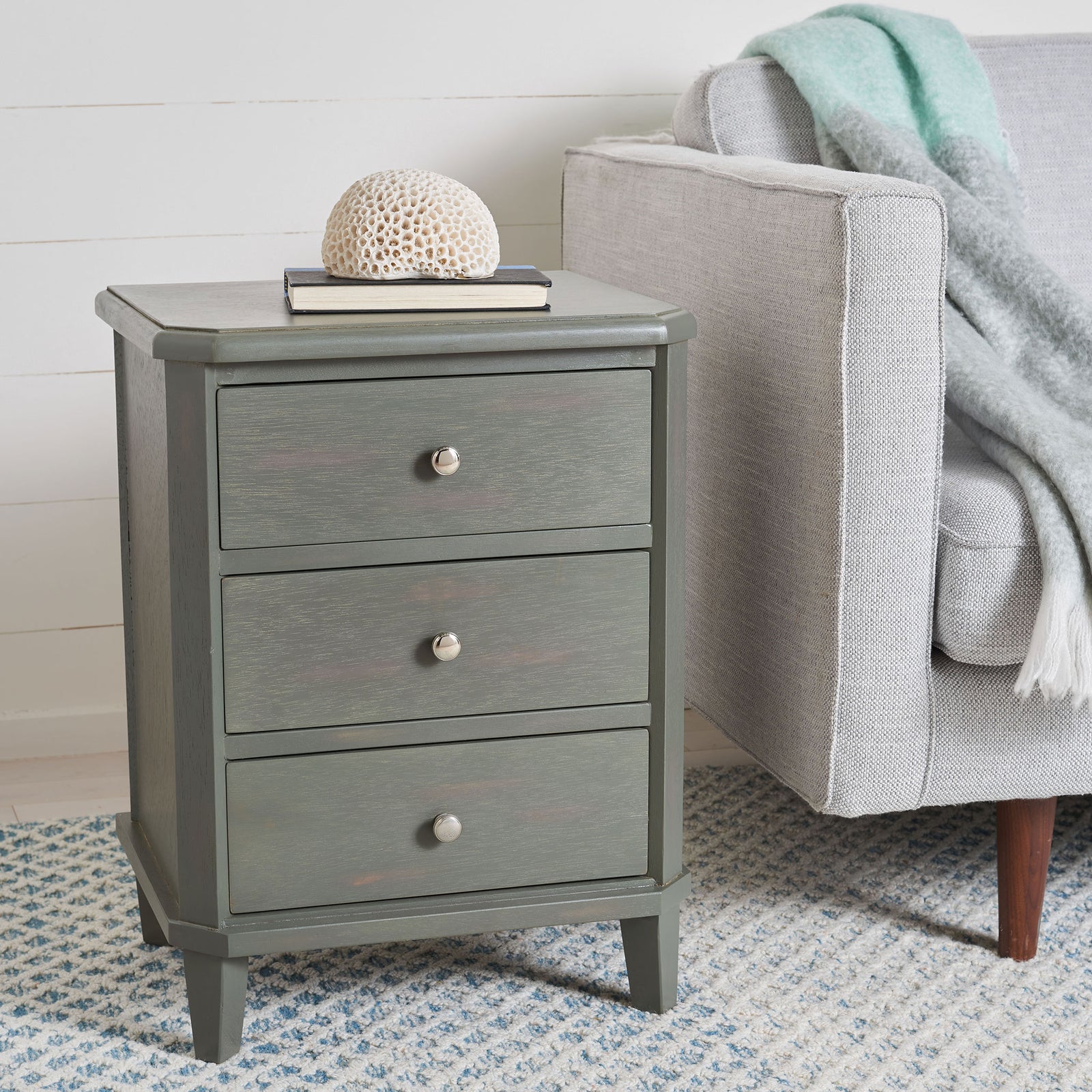 Three silver-knobbed drawers offer sofa-side storage in a compact ash gray nightstand. || AMH6629A || front_angle_room