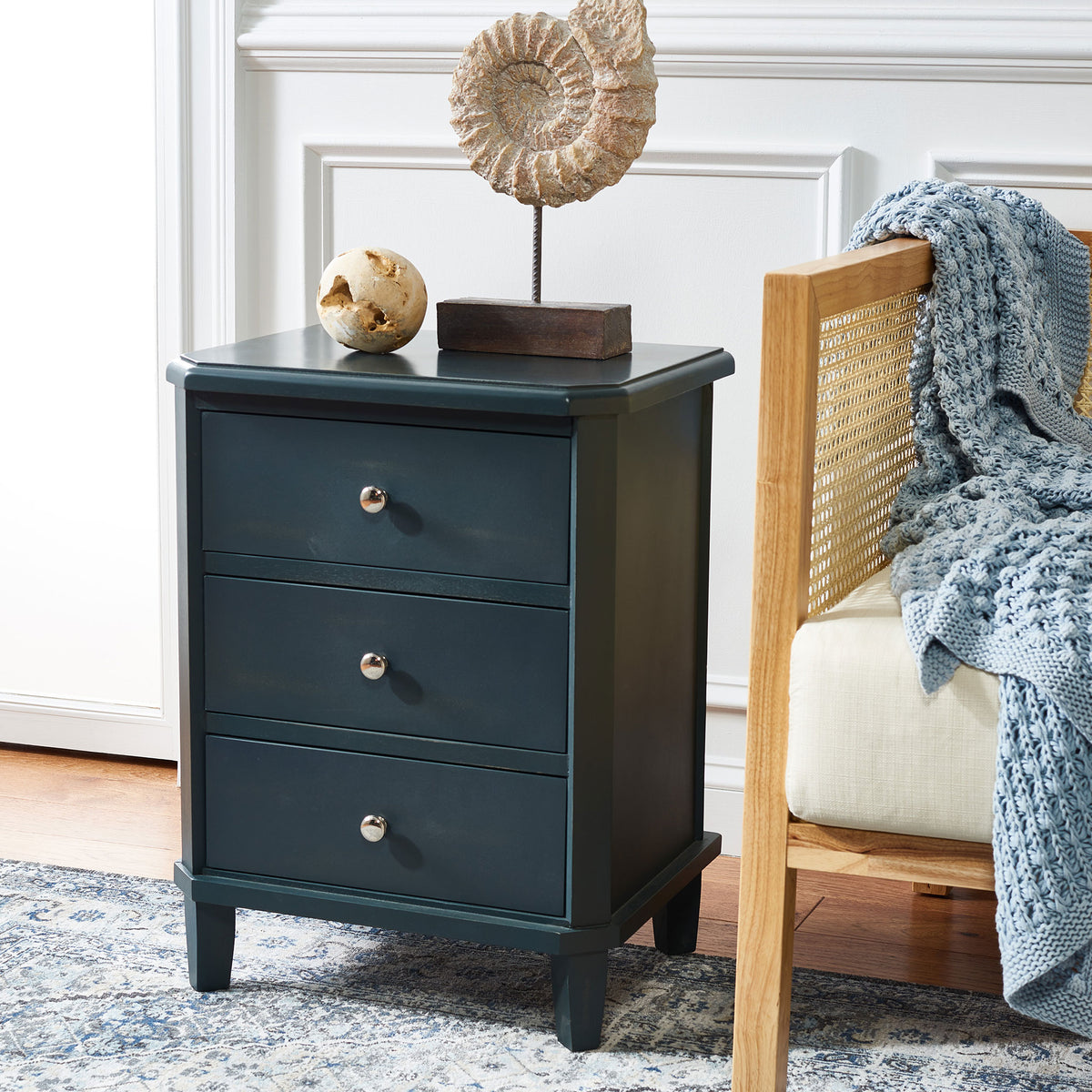 Dark teal drawers with silver knobs offer handy storage beside a cozy accent chair. || AMH6629B || front_angle_room