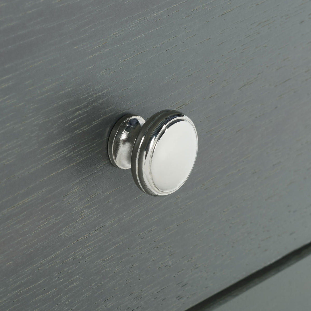 A bright round knob accents the lightly distressed gray drawer front. || AMH6630A || handle_studio