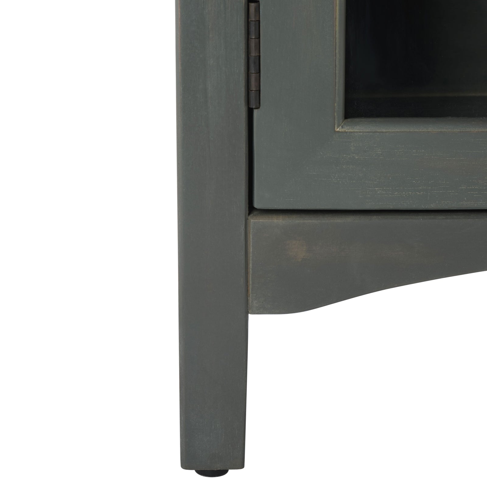 A slim wood leg and gently arched apron finish the base of the glass-front cabinet. || AMH6630A || leg_studio