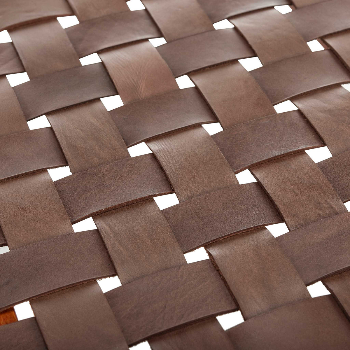 Broad cognac leather straps interlace to create a richly textured, open-grid seat.