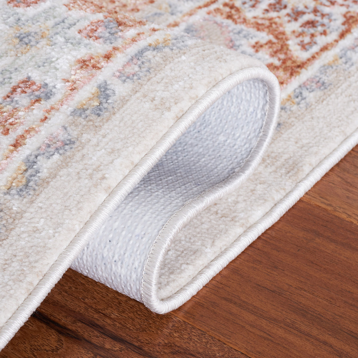 Flexible rug bends to reveal a secure backing and low-pile surface texture. || BLR202B-5 || backing_room