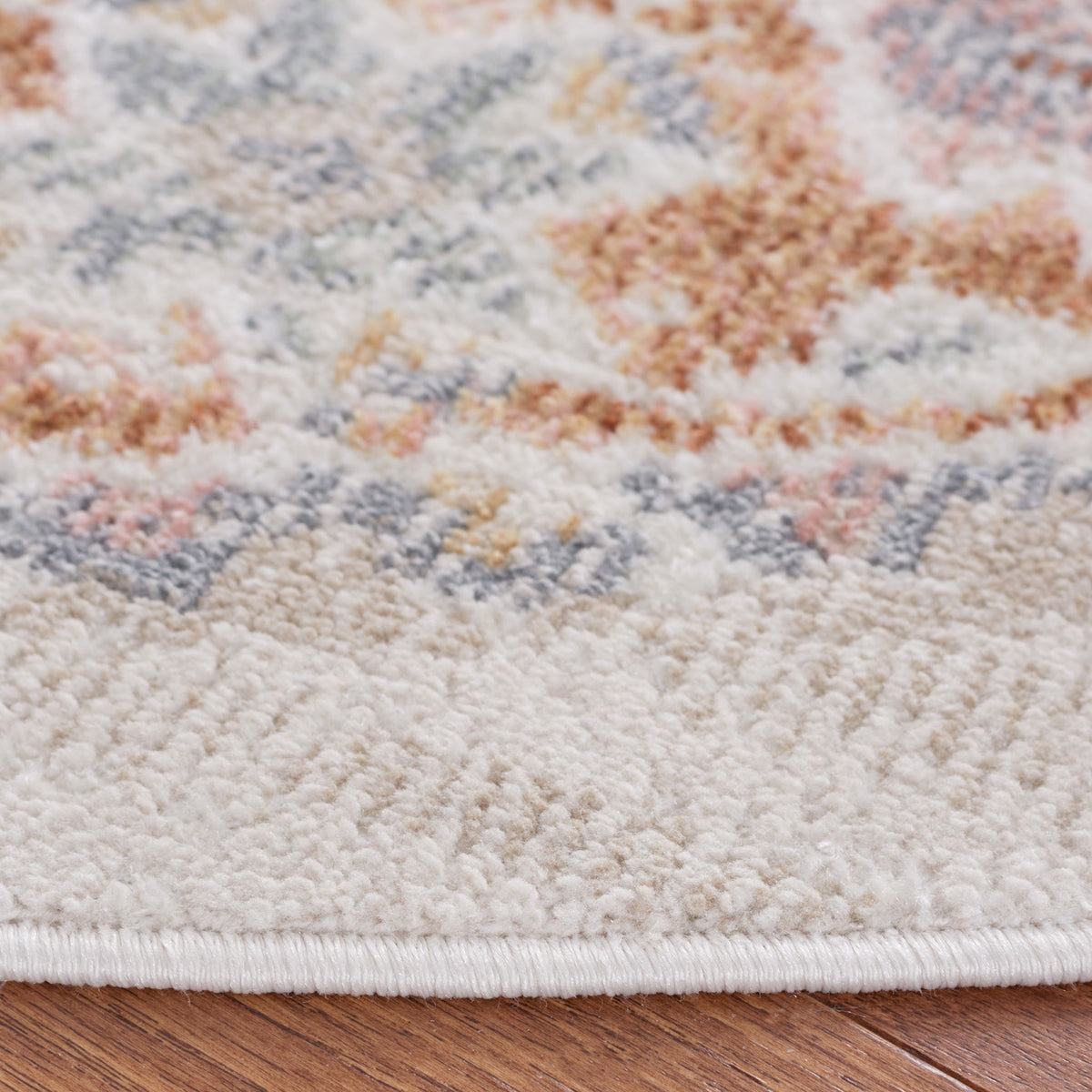 Soft, textured pile and bound edge highlight the faded beige and rust pattern || BLR202B-7R || detail_room