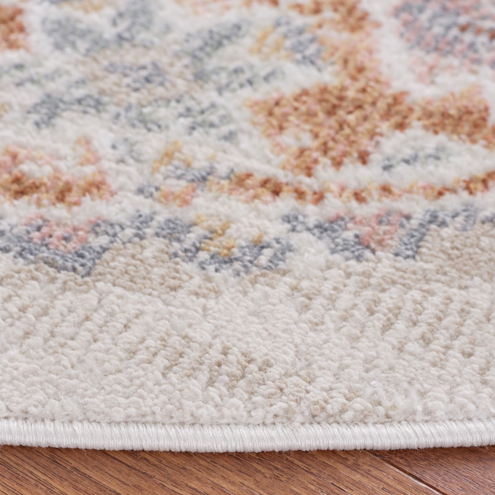 Soft, textured pile and bound edge highlight the faded beige and rust pattern || BLR202B-7R || detail_room
