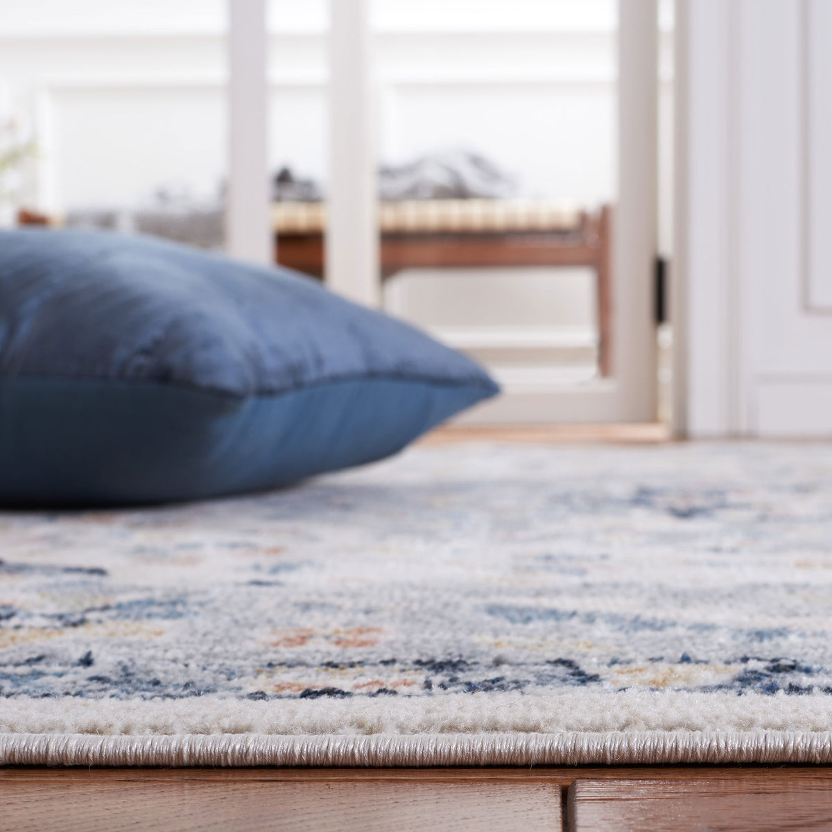 Plush, low-profile pile sits neatly on hardwood, blending soft blues with warm ivory || BLR204B-5 || detail_room