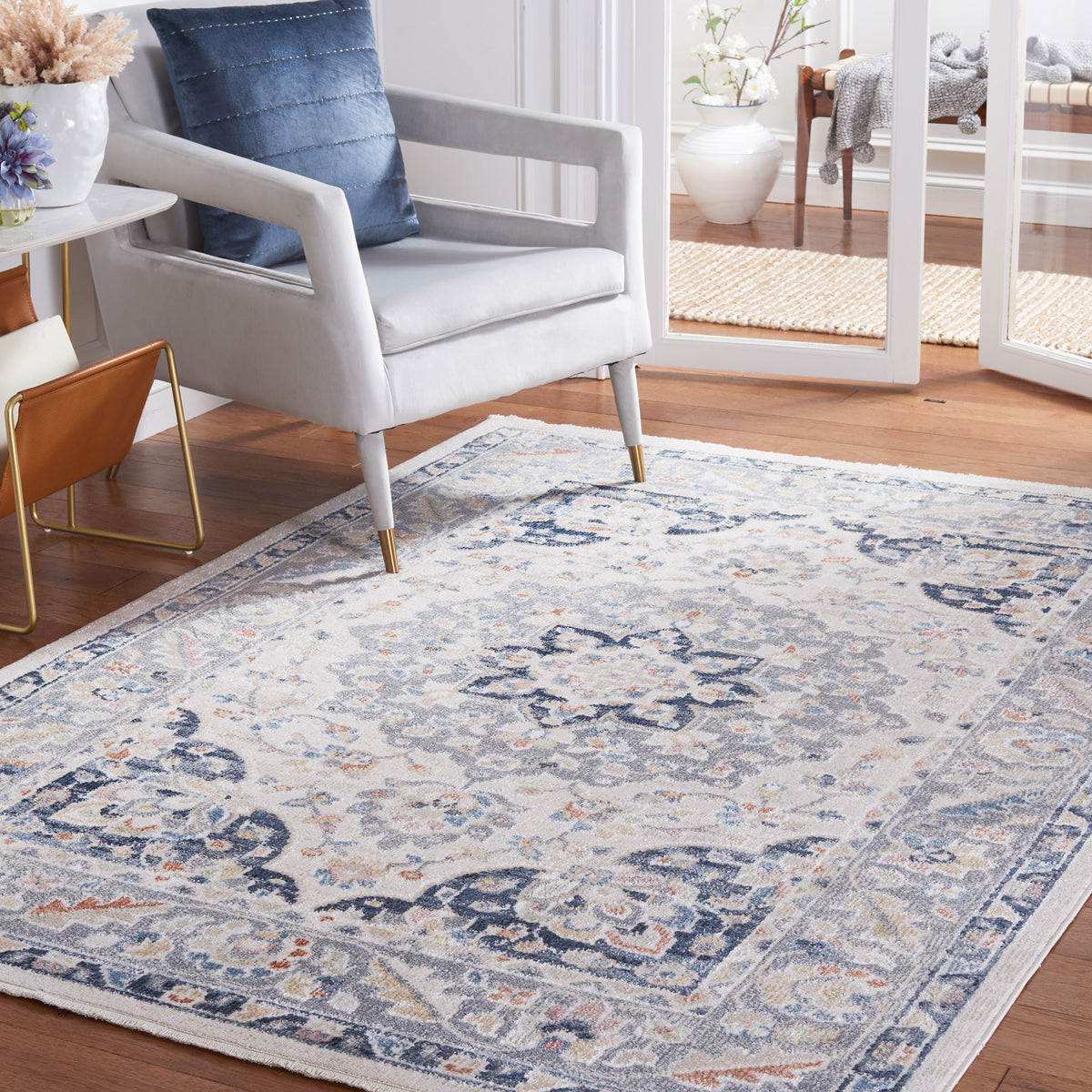 Vintage-style beige and navy rug warms the room with a soft, easy-care feel and classic medallion pattern || BLR204B-5 || front_angle_room